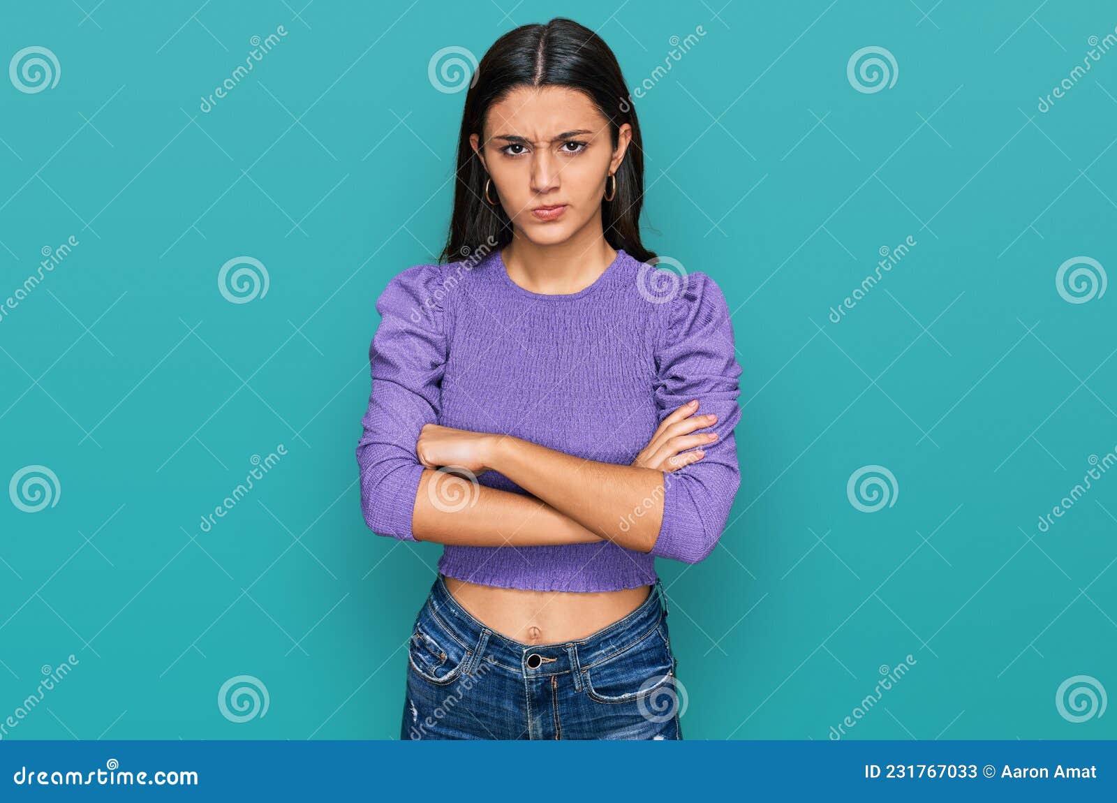 young hispanic girl wearing casual clothes skeptic and nervous, disapproving expression on face with crossed arms