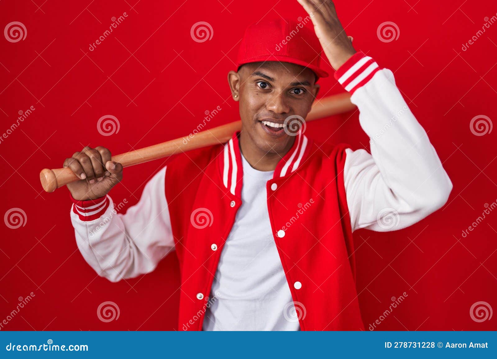 Young Hispanic Man Playing Baseball Holding Bat Surprised with Hand on