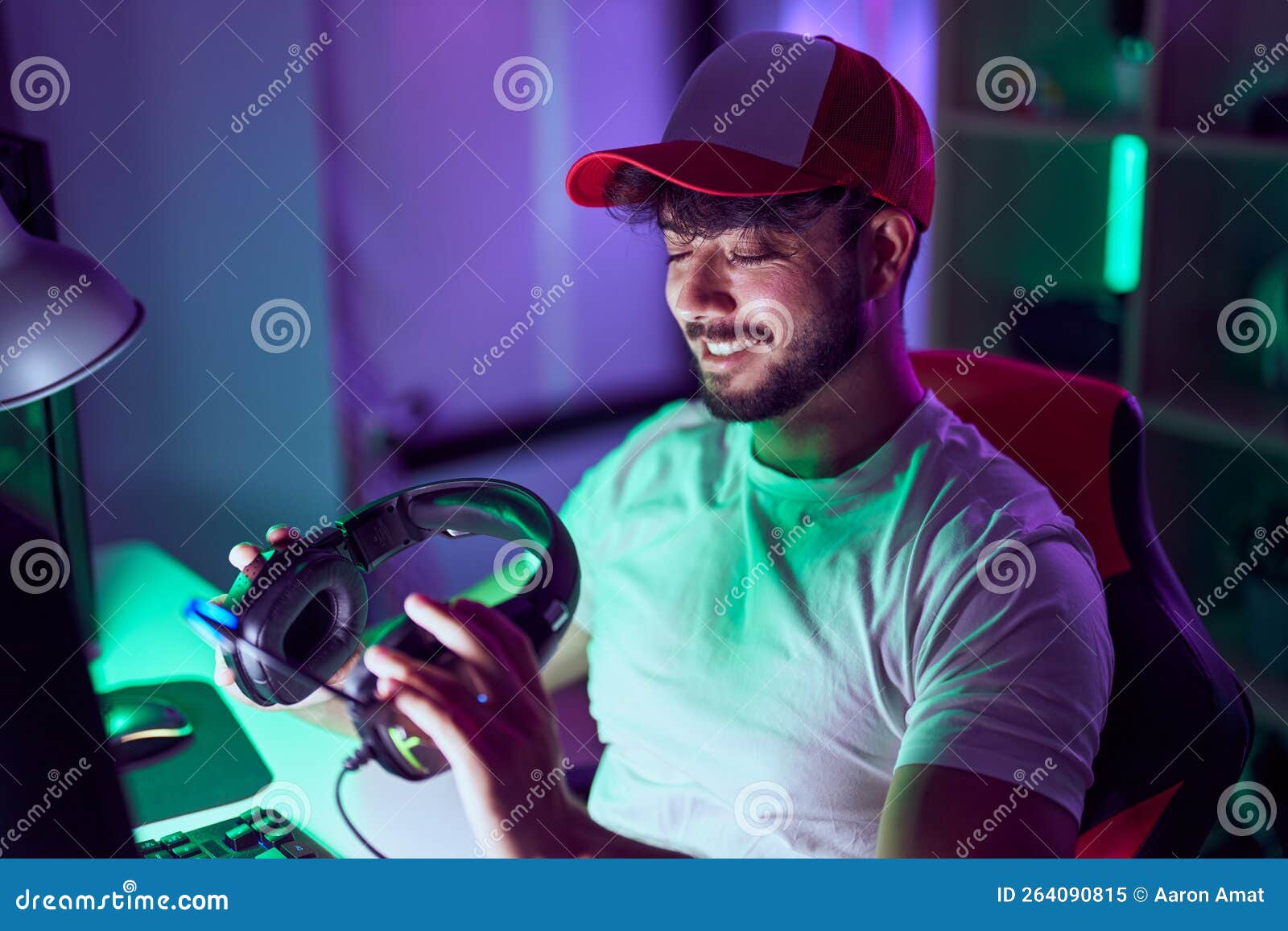 young hispanic man streamer smiling confident using computer at gamin room