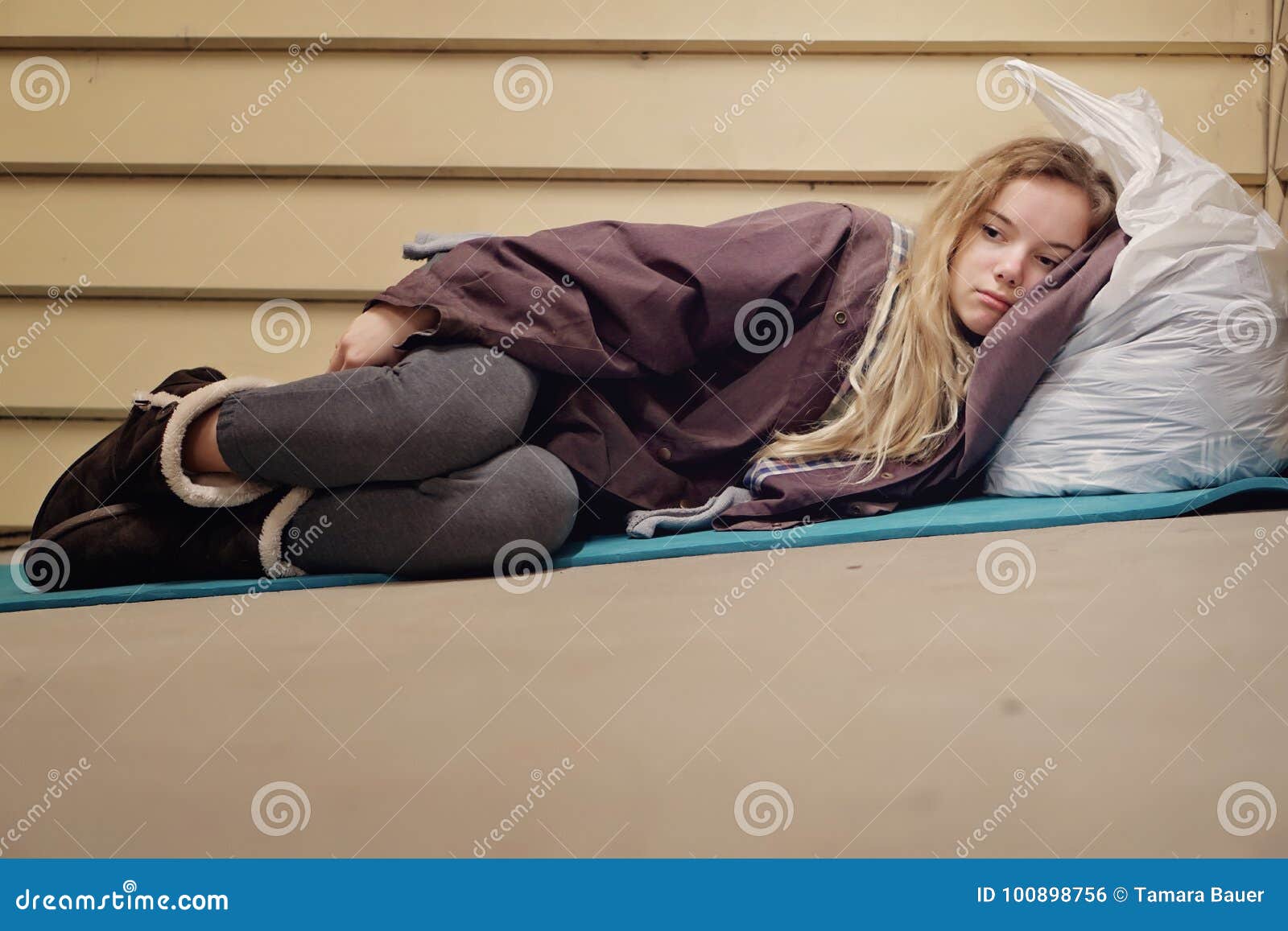 homeless young teen taking shelter