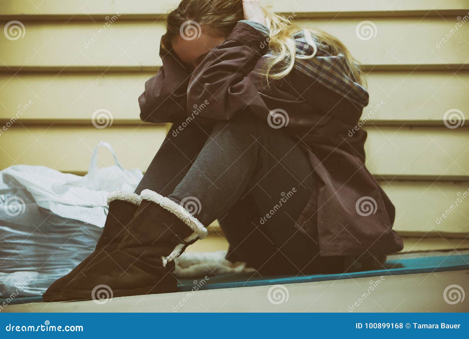 homeless young teen taking shelter