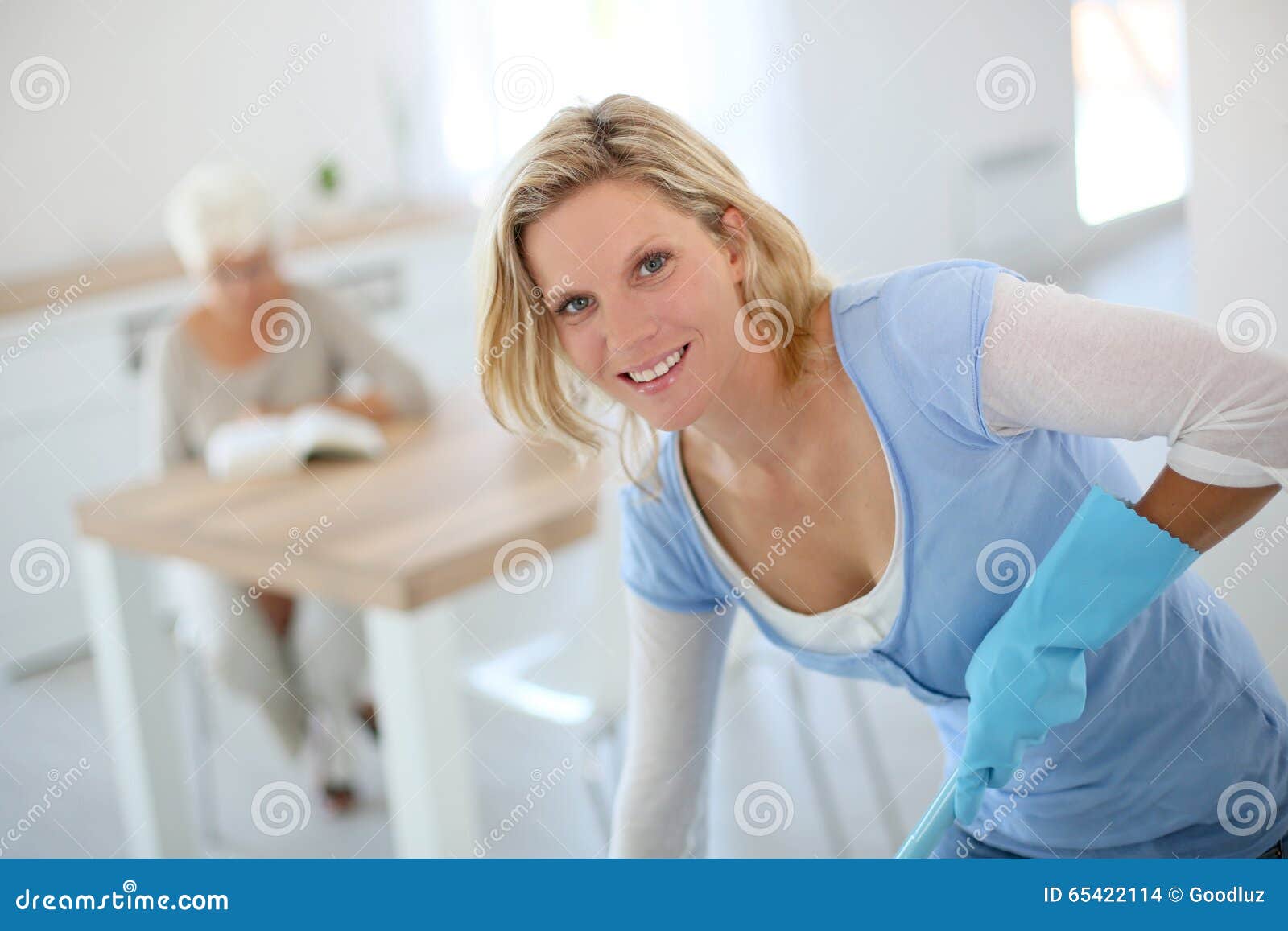 young housekeeper cleaning home