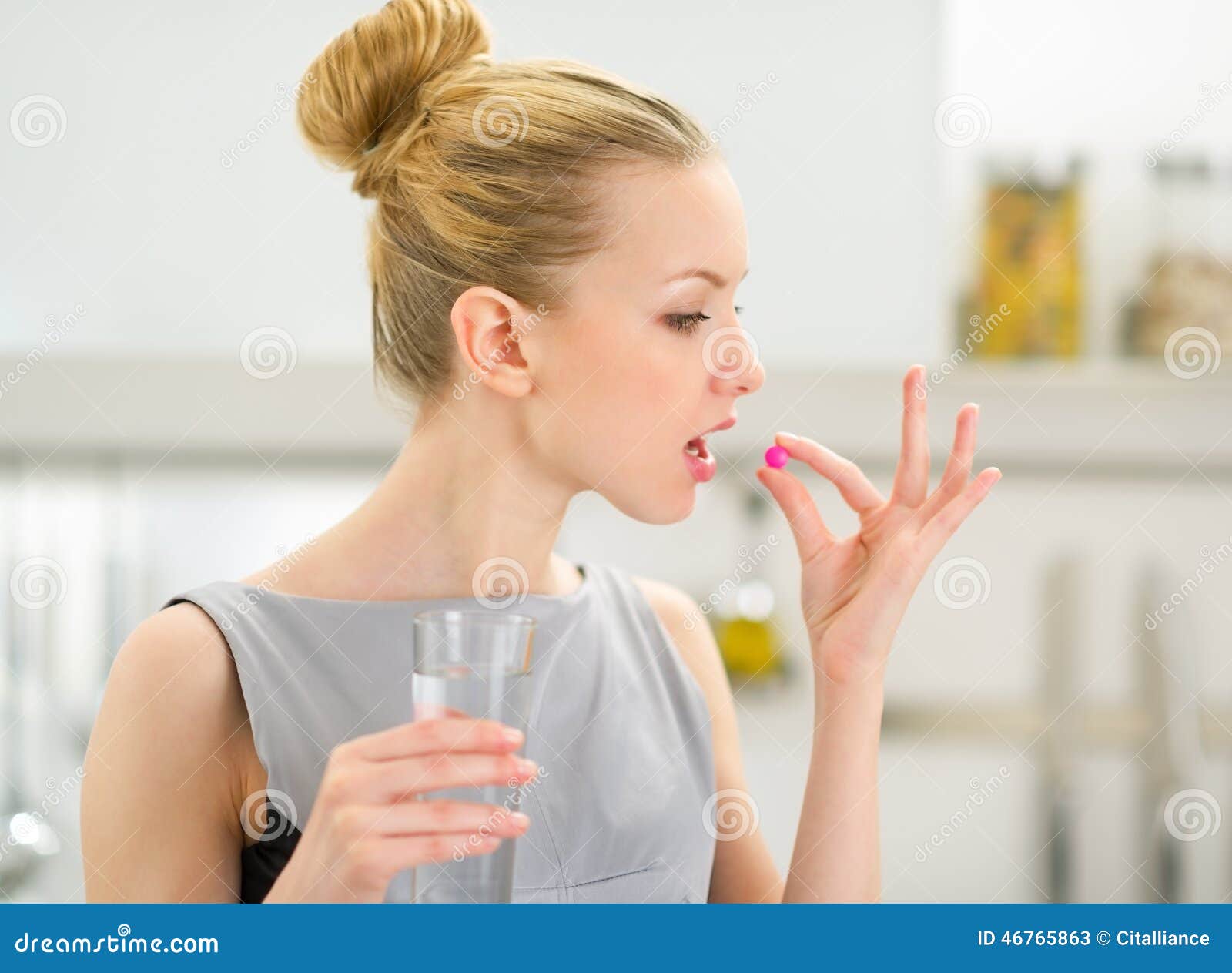 Young Housewife Taking Pill in Kitchen Stock Image Image of