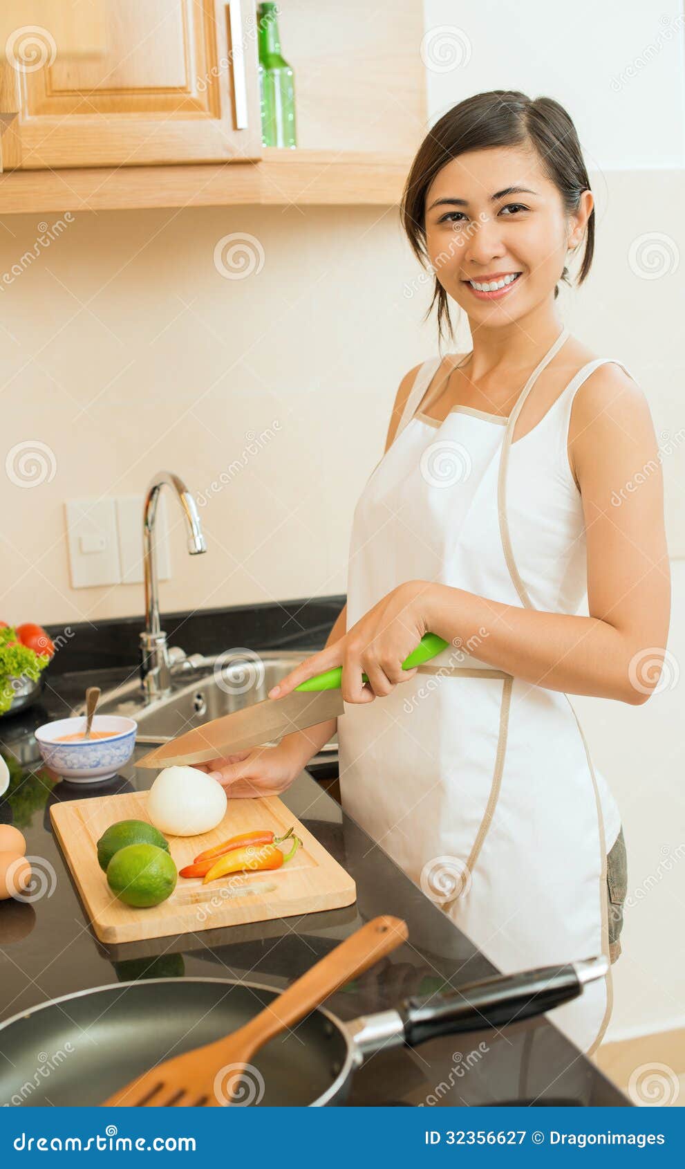 Funny young housewife cooking in kitchen Stock Photo - Alamy