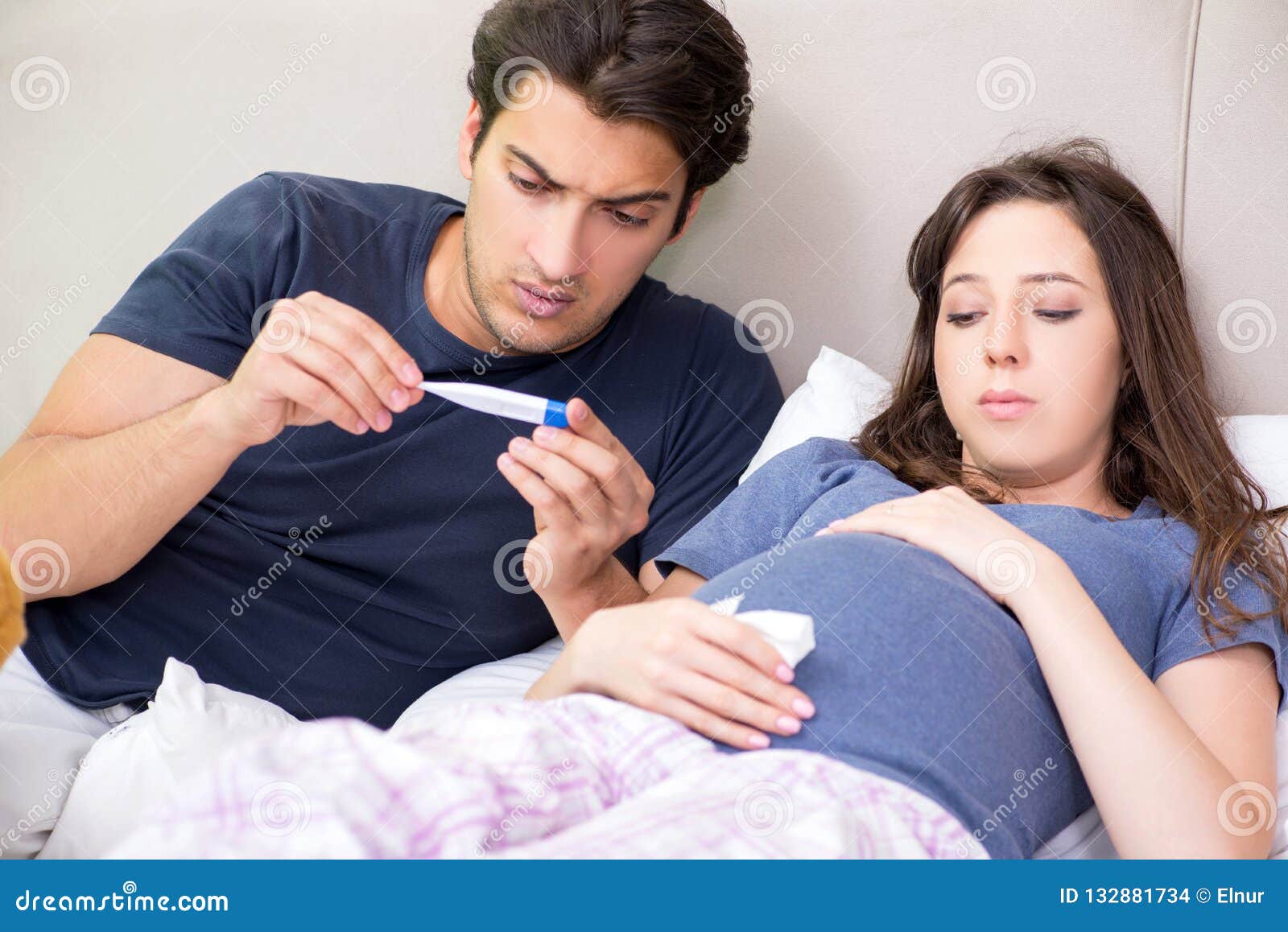 The Young Husband Looking After His Pregnant Wife Stock Photo I