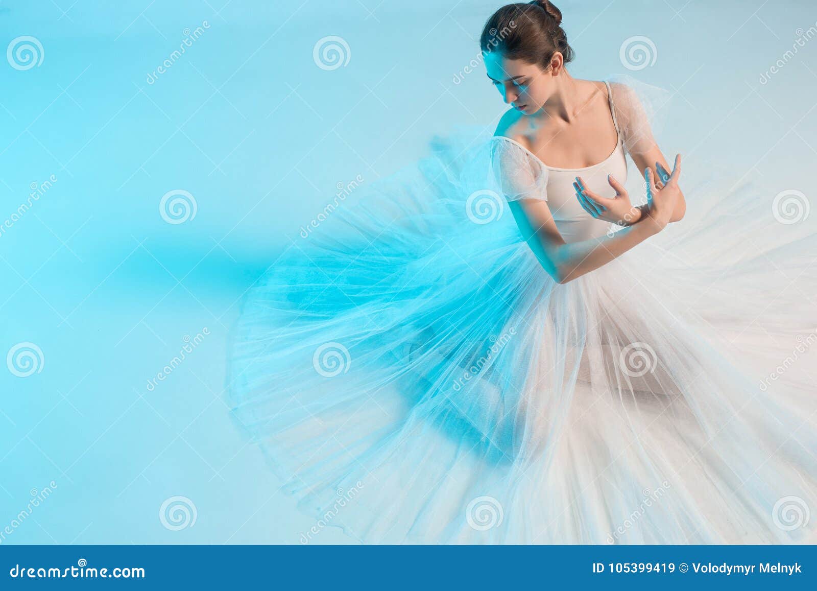 Young and Incredibly Beautiful Ballerina is Dancing in a Blue Studio ...