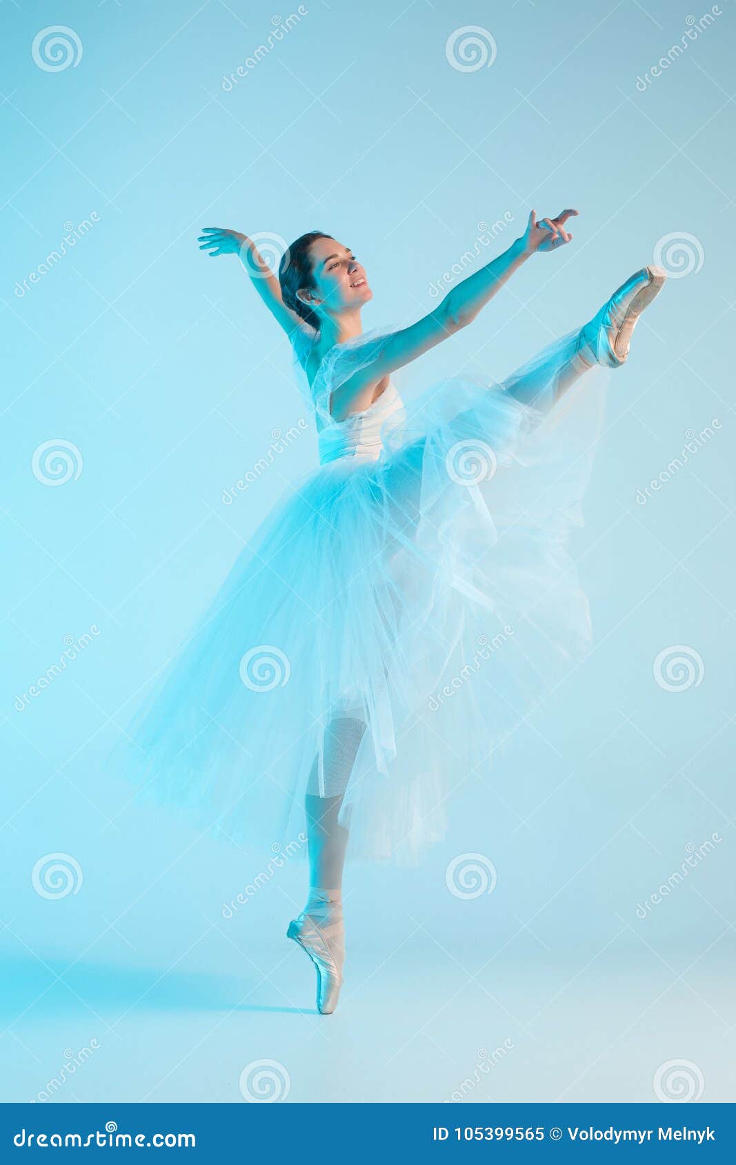 Young and Incredibly Beautiful Ballerina is Dancing in a Blue Studio ...