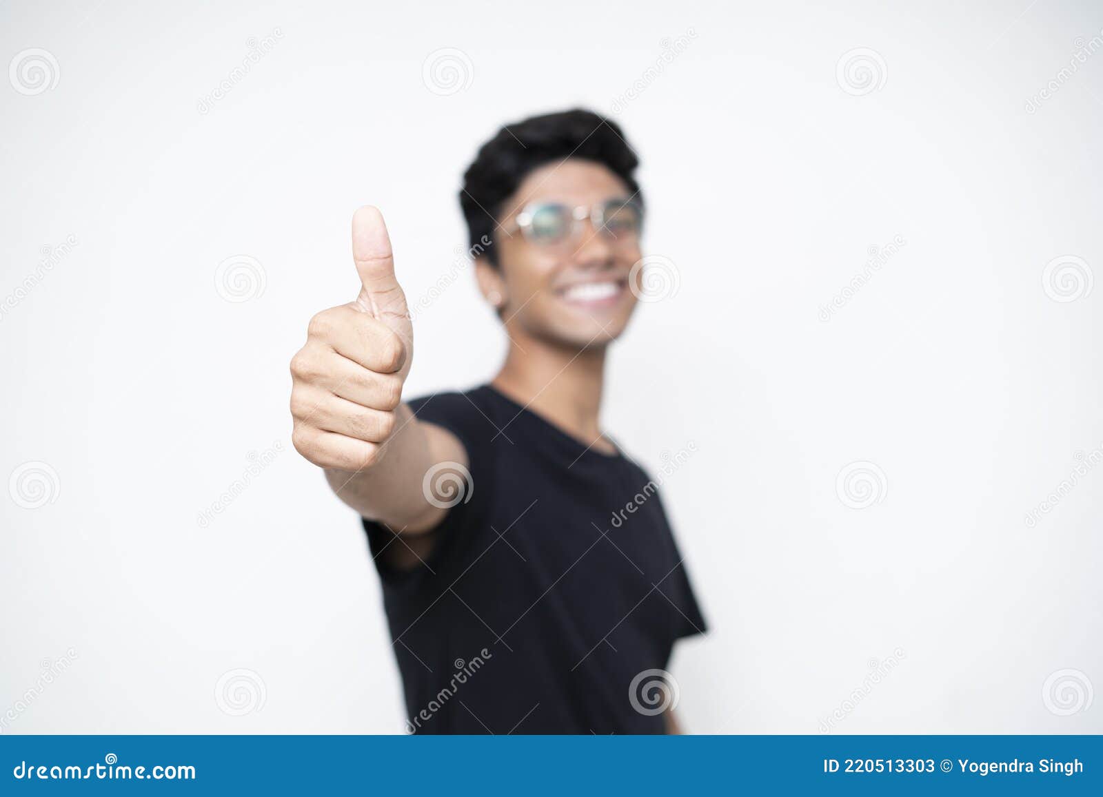 Young Indian Boy Showing Thumbs Up To The Camera Standing On A White ...