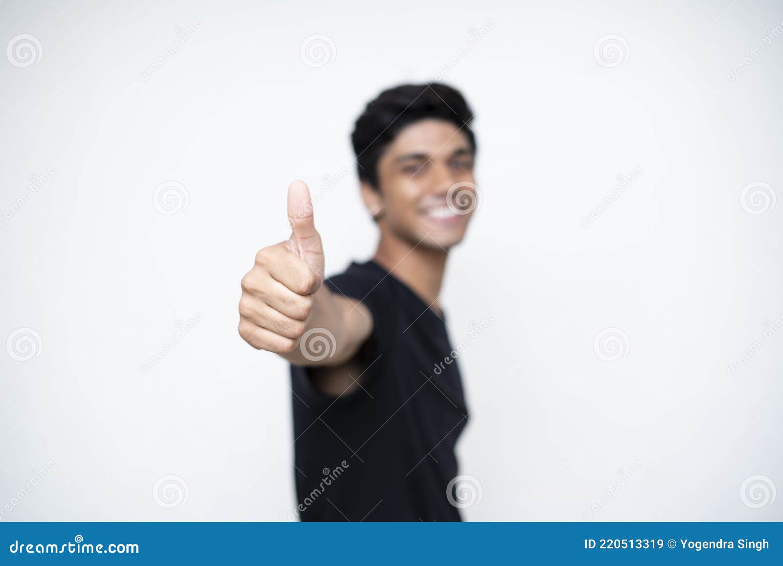 Young Indian Boy Showing Thumbs Up To the Camera Standing on a White ...