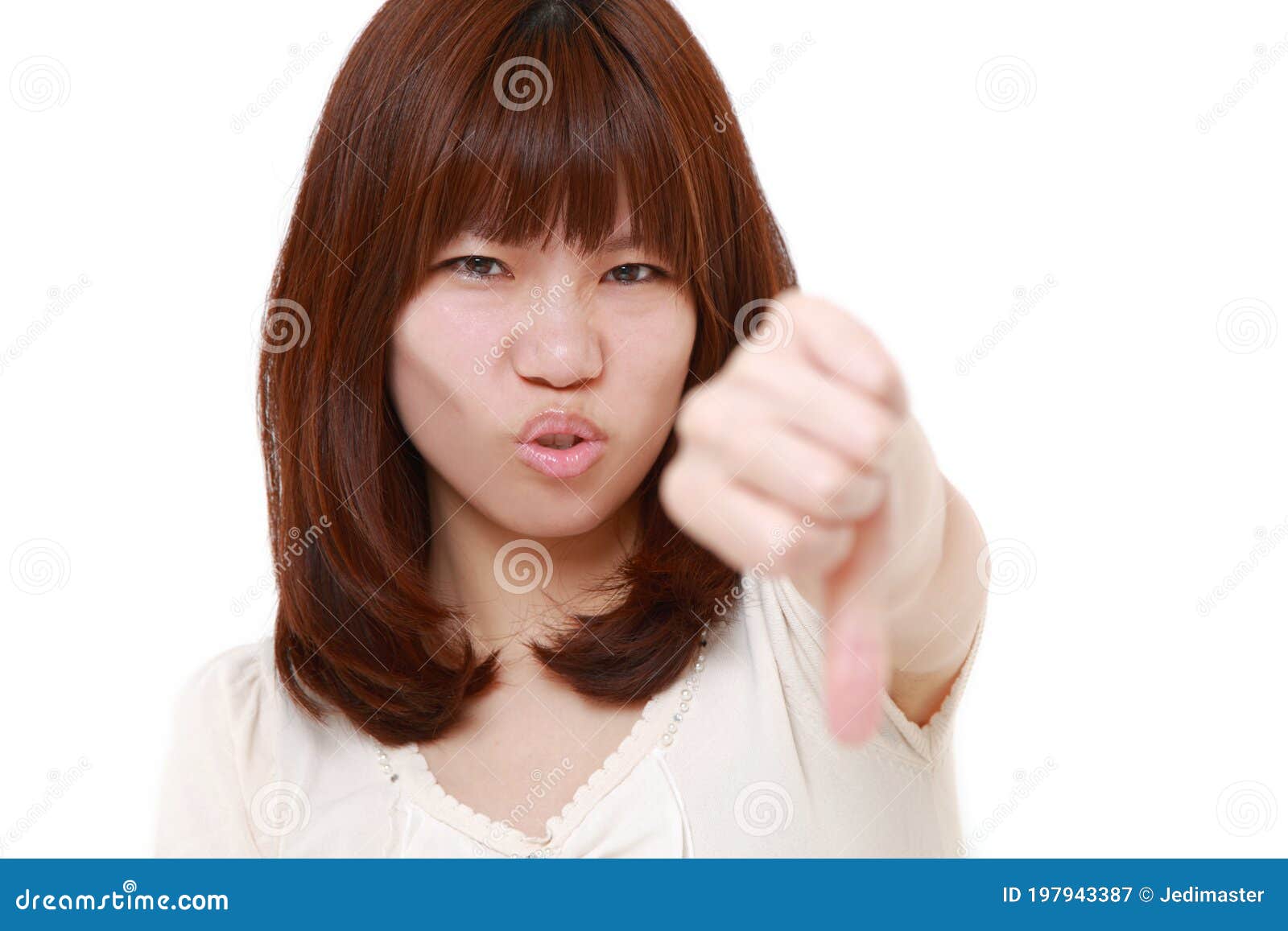 Young Japanese woman with thumbs down gesture. Studio shot of young Japanese woman on white background