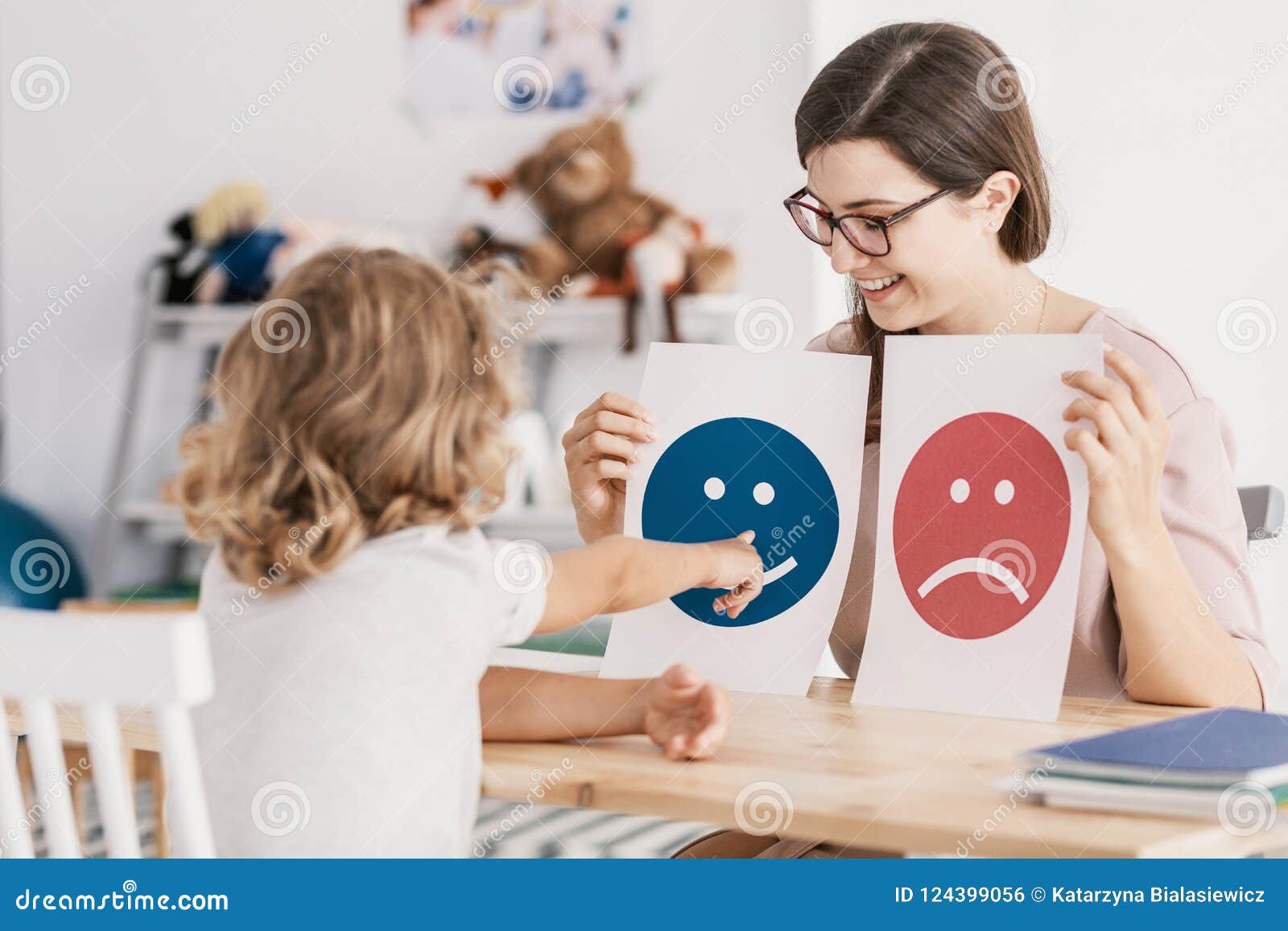 young kid pointing at graphic with a smiley face during a psycho