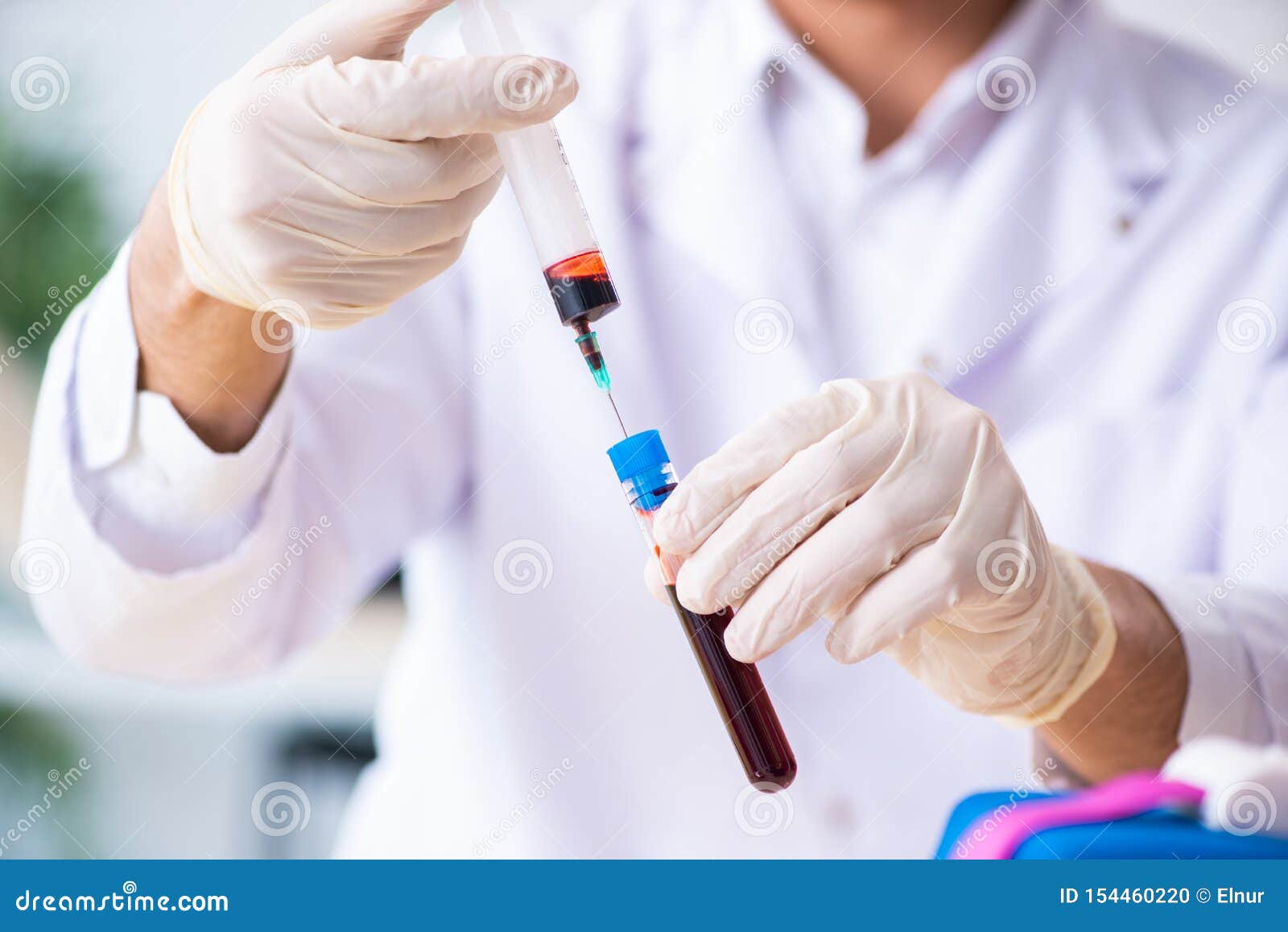 Young Lab Assistant Testing Blood Samples in Hospital Stock Photo