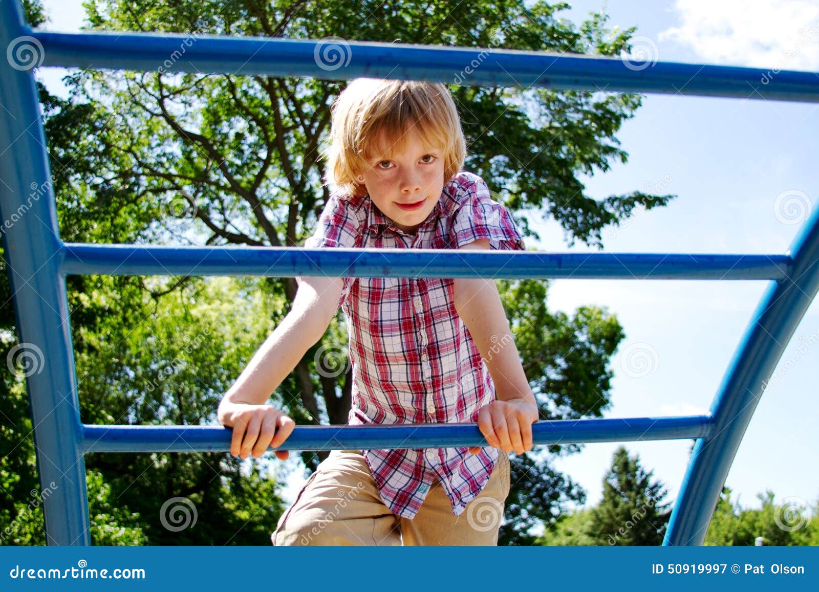 young lad climbing on playground