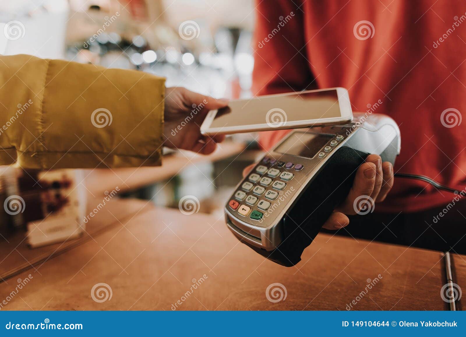 young lady pay bill via contactless payments