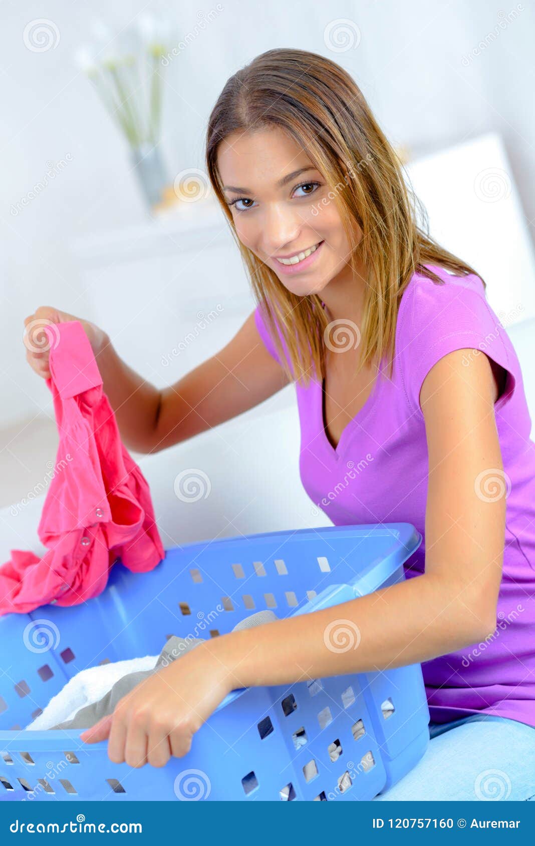 Young lady sorting laundry stock photo. Image of household 120757160
