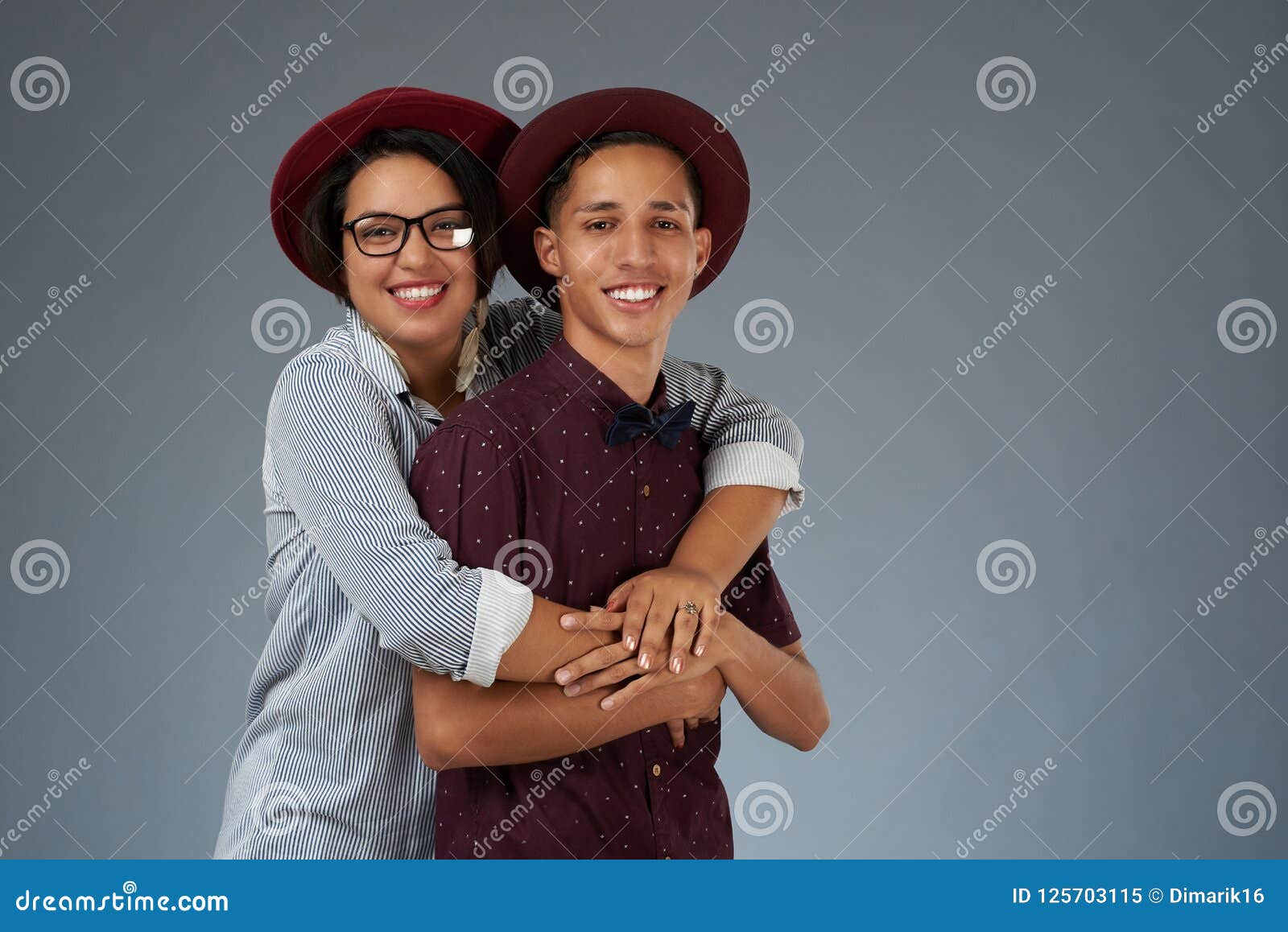 https://thumbs.dreamstime.com/z/young-latin-couple-young-latin-couple-smile-teeth-hugging-isolated-gray-studio-background-125703115.jpg