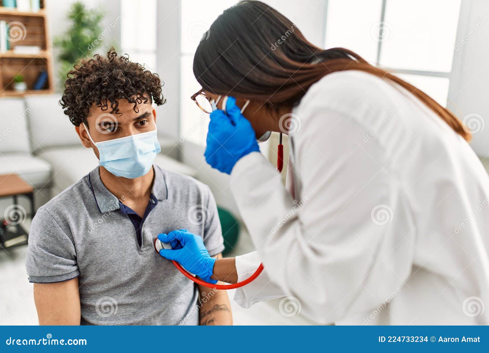 young latin doctor woman auscultate heart man using stethoscope at medical room