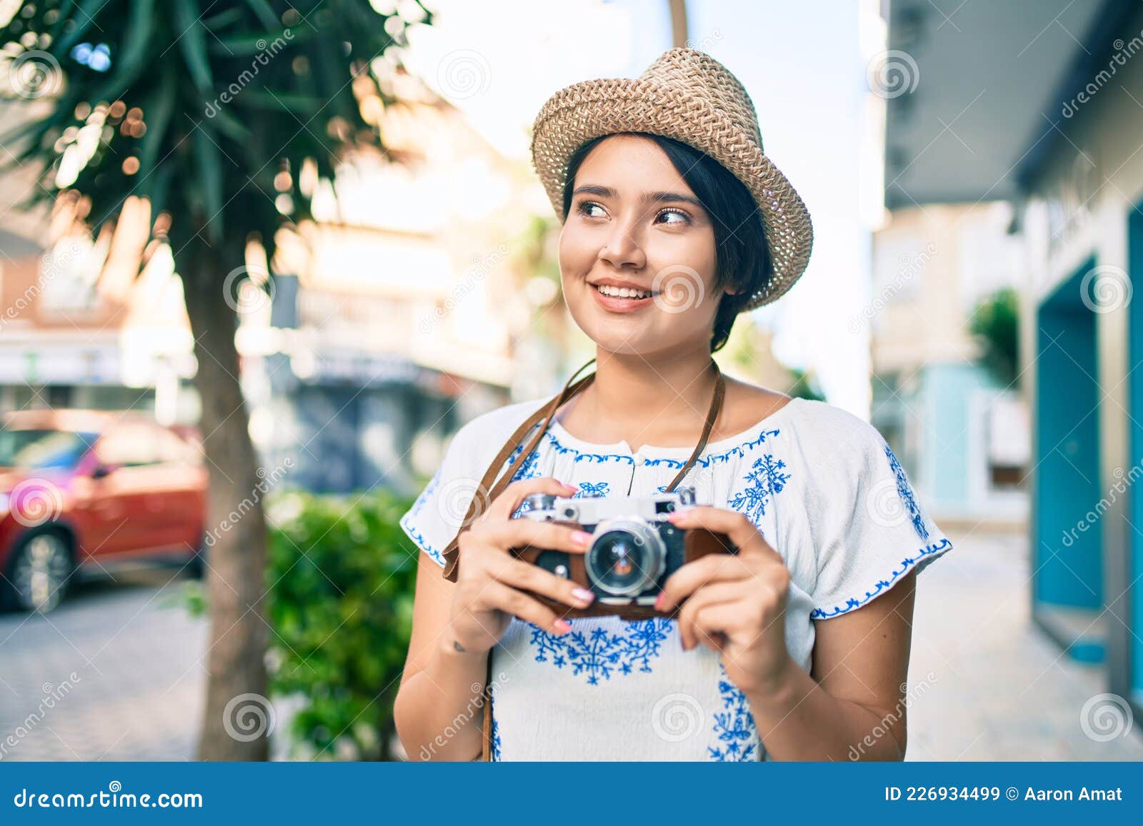 Young Latin Tourist Girl on Vacation Smiling Happy Using Vintage Camera ...
