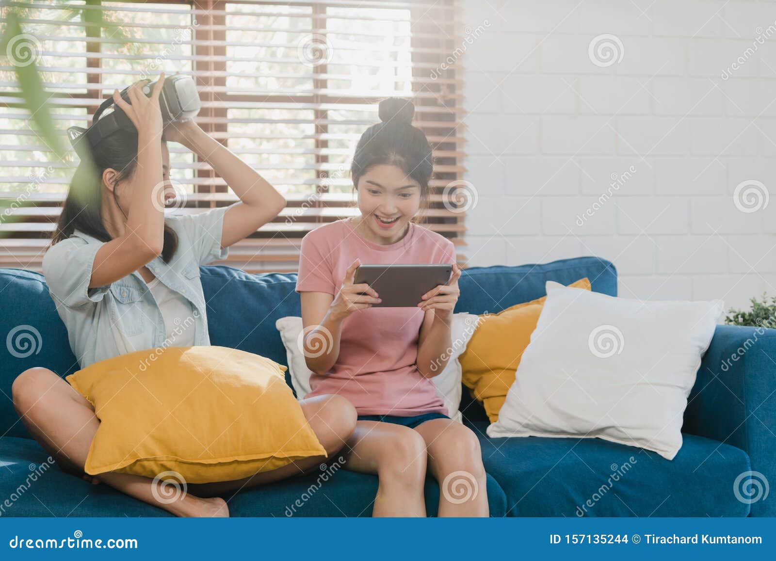 Young Lesbian Lgbtq Asian Women Couple Using Tablet At Home Asian