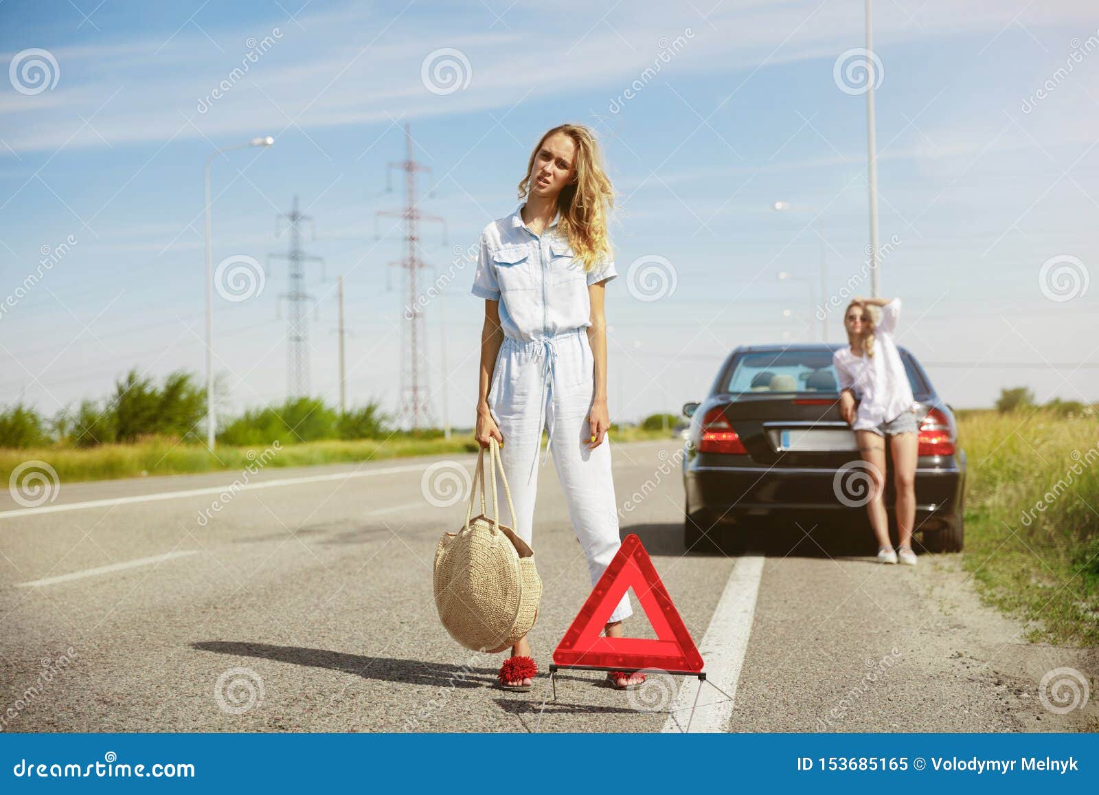 young lesbian`s couple going to vacation trip on the car in sunny day