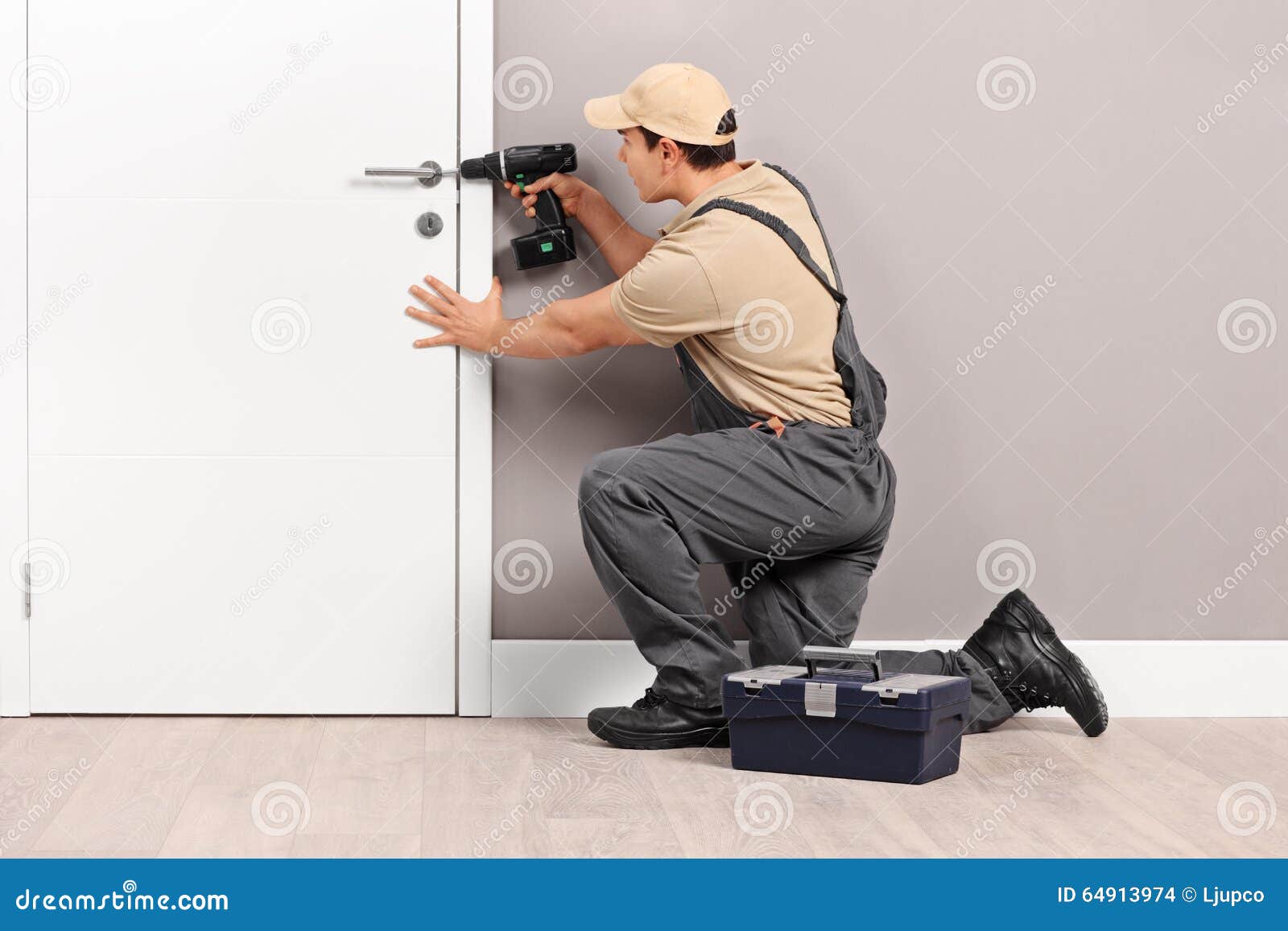 Young Locksmith Installing a Lock on a Door Stock Photo Image of