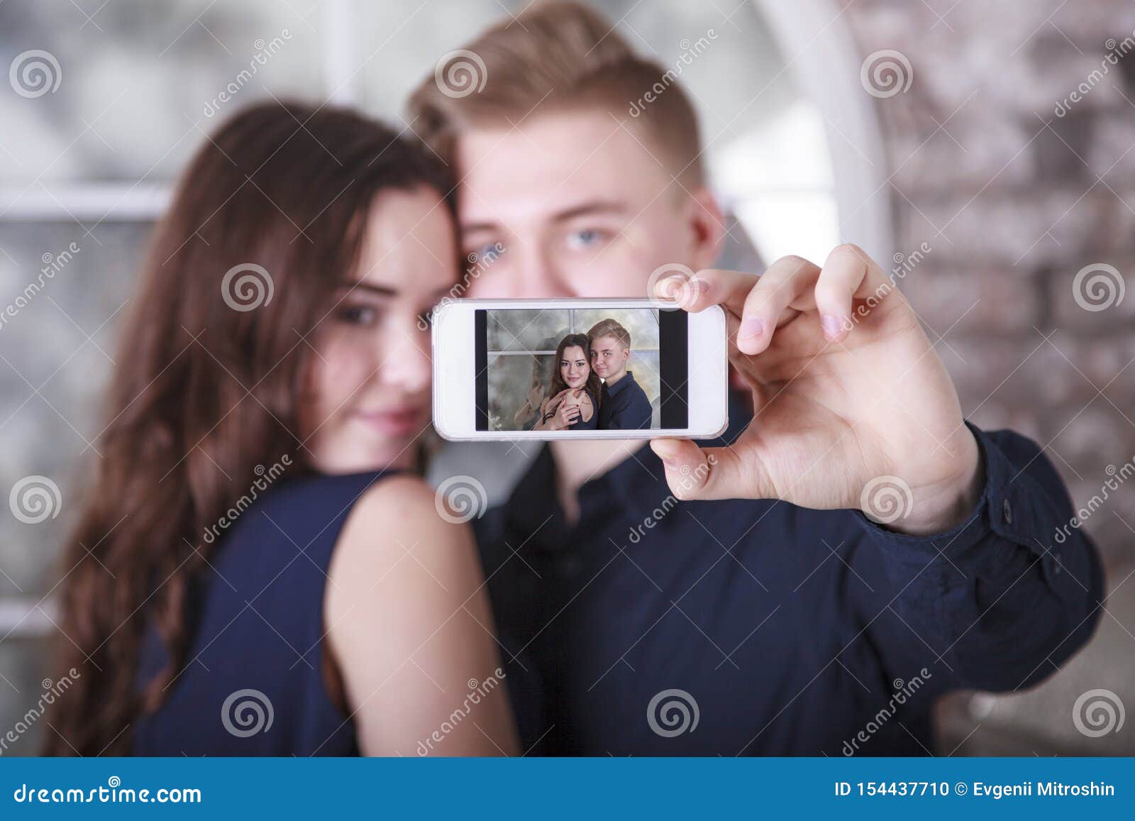 Attractive boyfriend and girlfriend with European appearance pose for  making selfie, hold smart phone, pose against nature background, have fun  together. Youth, lifestyle and technology concept Stock Photo | Adobe Stock