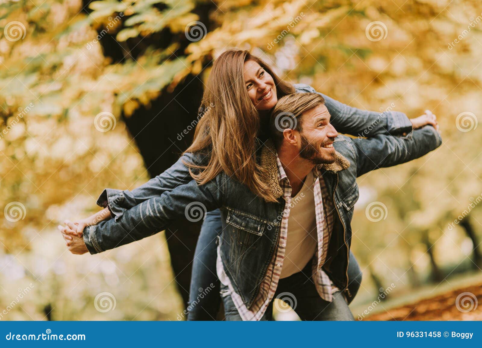 Young Loving Couple Having Fun In The Autumn Park Stock Photo Image
