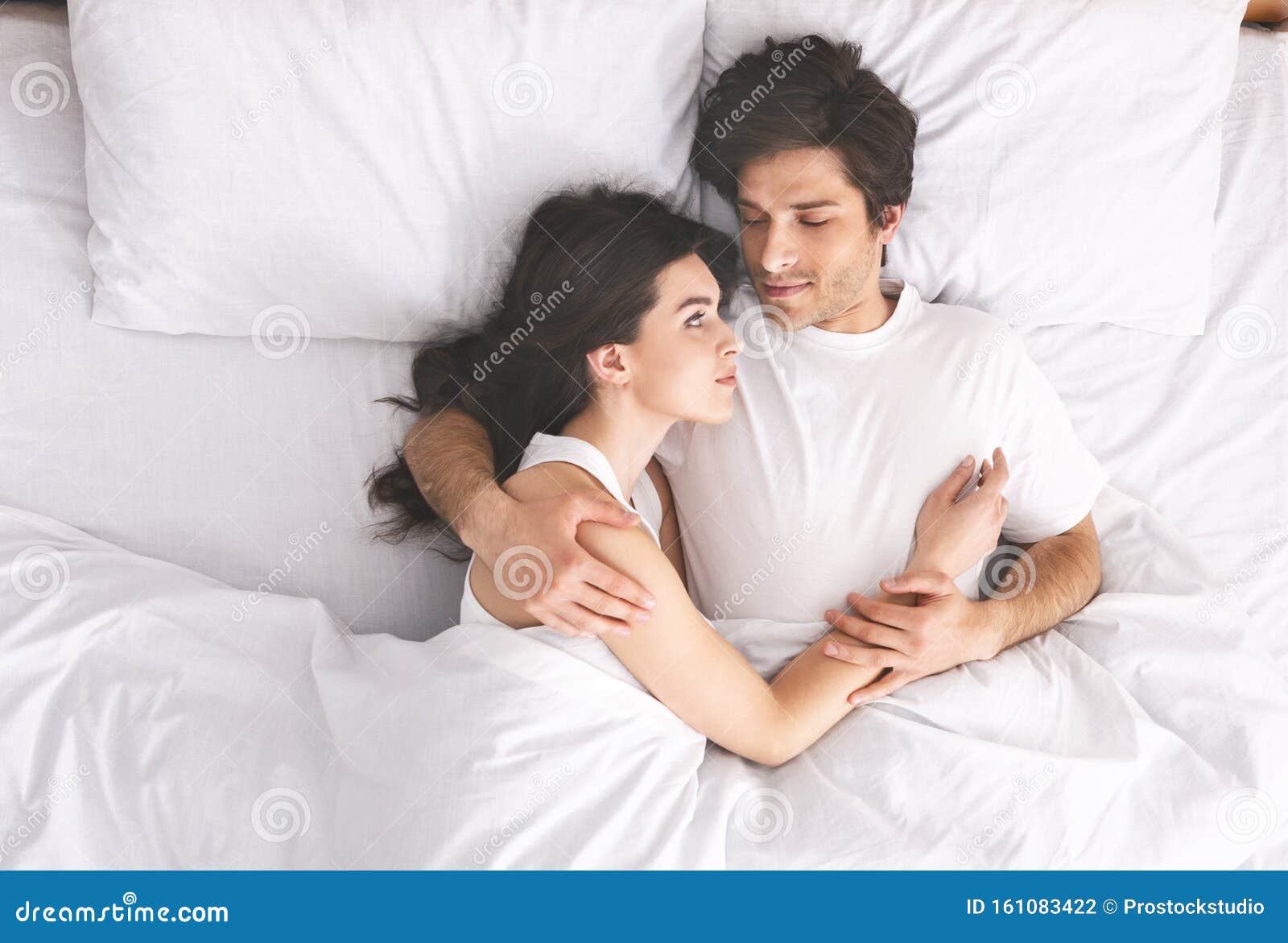 Young Loving Couple Sleeping in Bed and Hugging Stock Photo ...