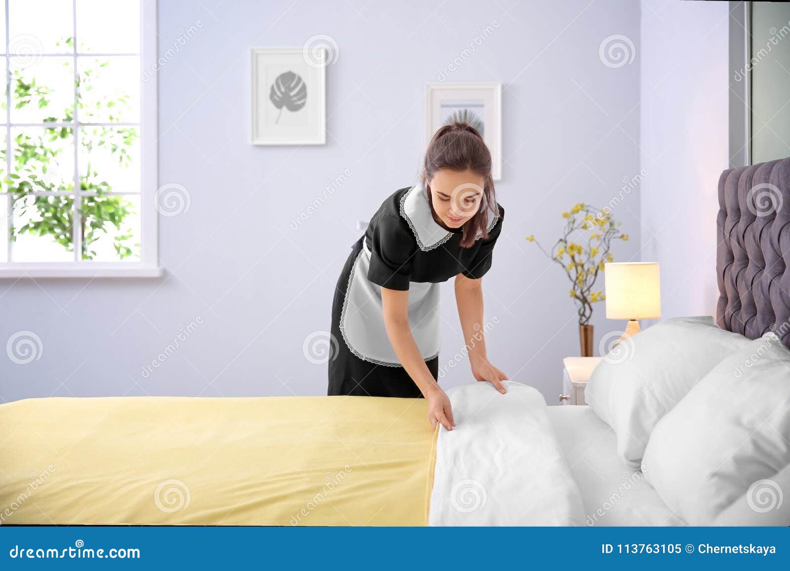 Young maid making bed stock image. Image of housemaid 113763105