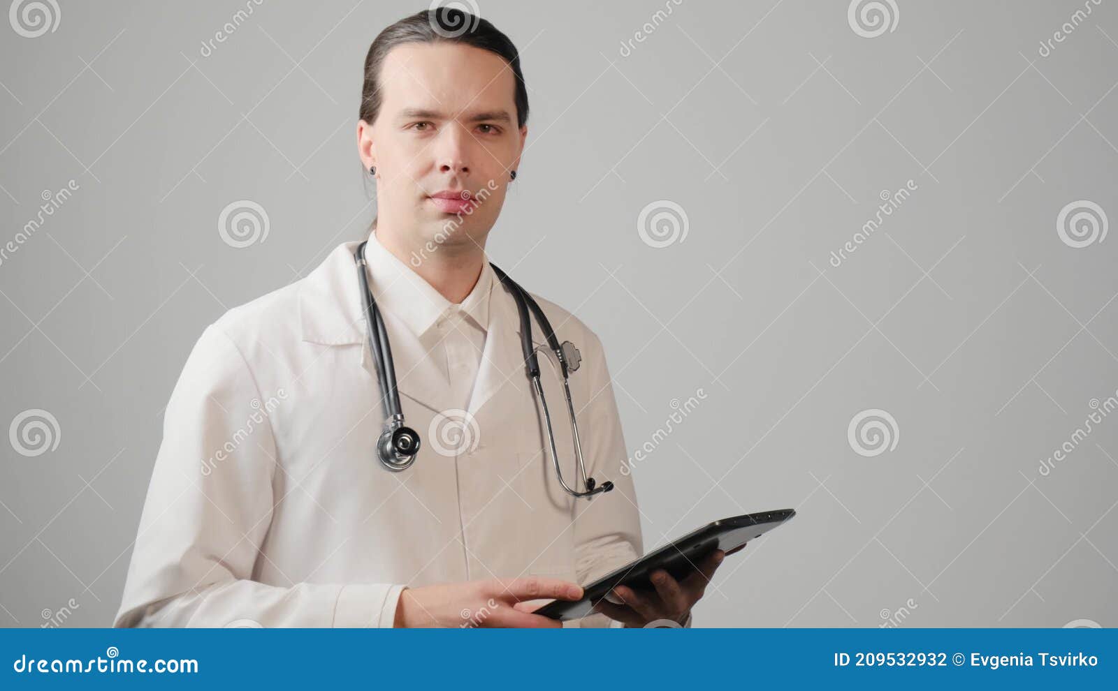 A Young Male Doctor with Long Hair in a Medical Gown, Uses a Tablet. Stock  Footage - Video of medical, physician: 209532932