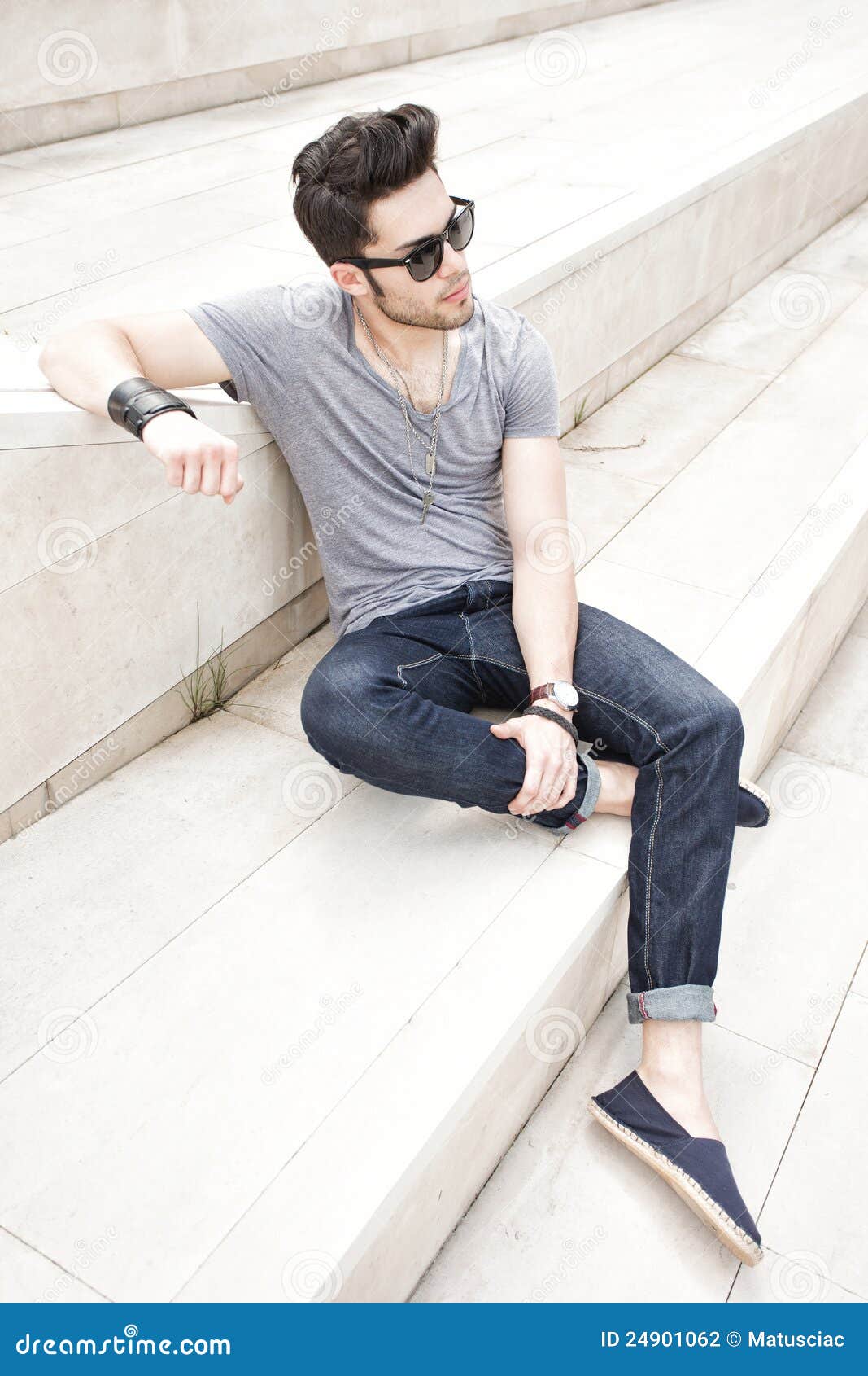 Sexy fashion man model dressed elegant holding a bag posing outdoor Stock  Photo by ©matusciac 24957745