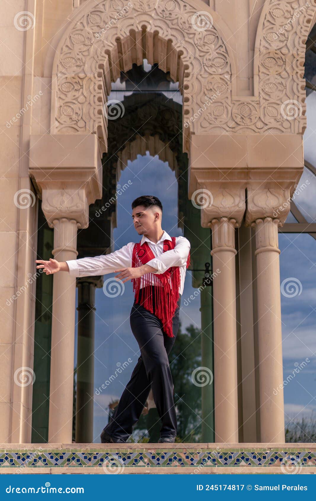 young male flamenco dancer in white shirt and red mantillo dancing