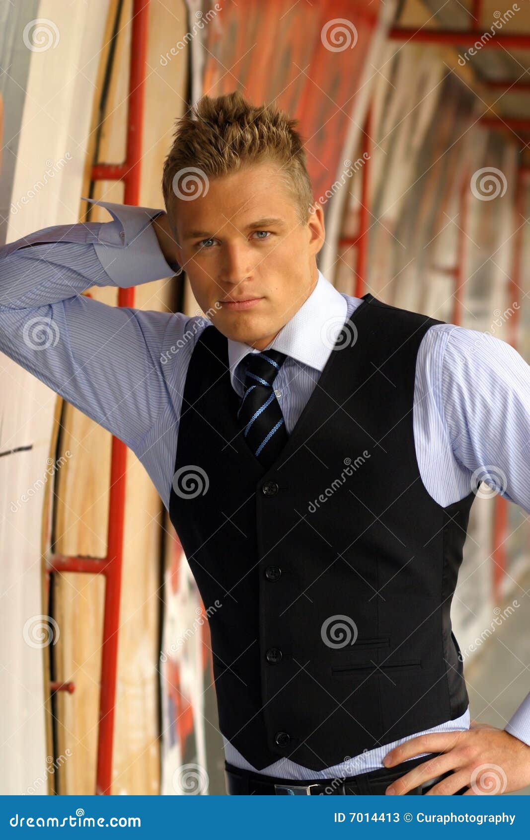 young male model leaning on wall