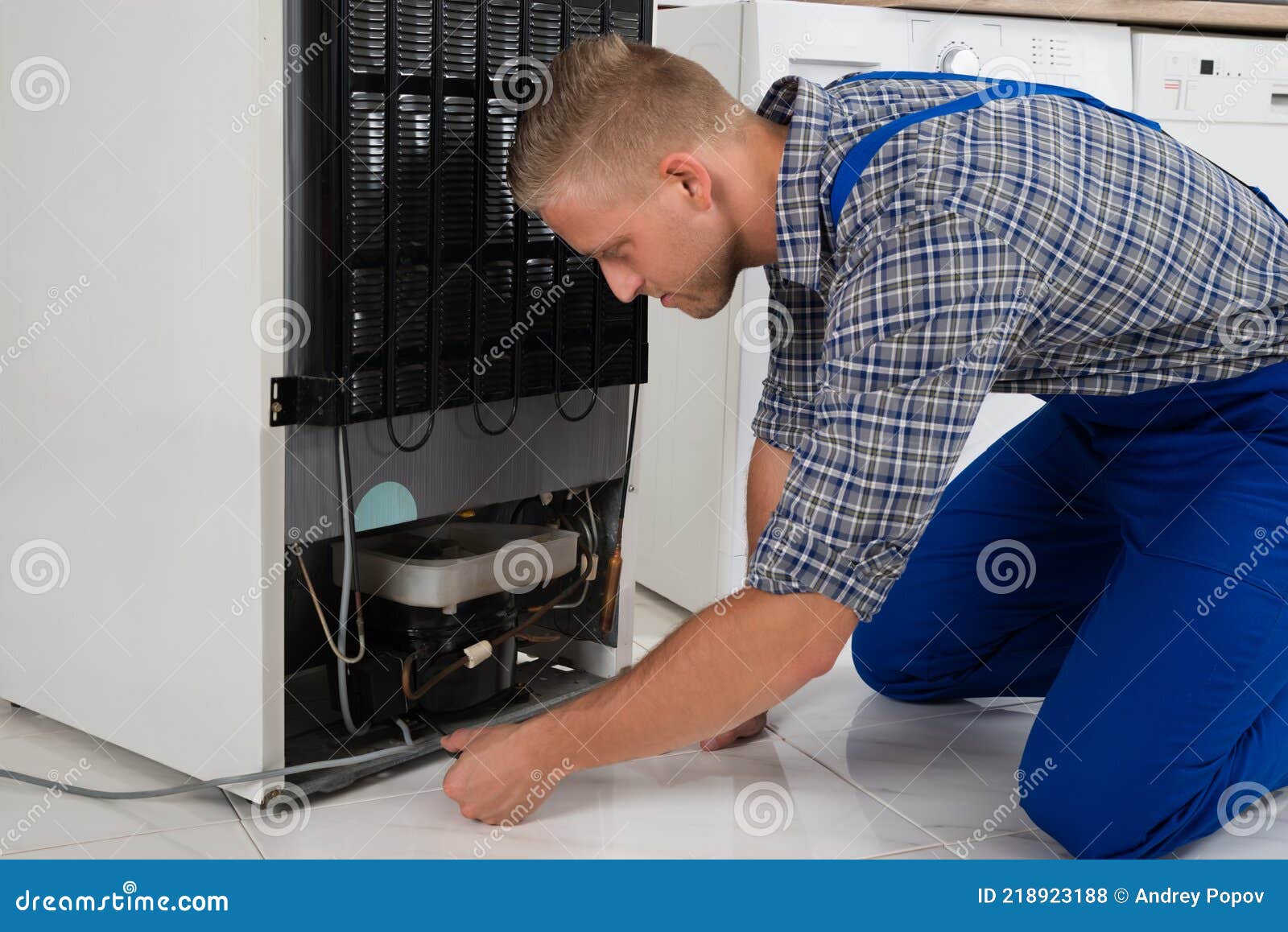 repairman making refrigerator appliance