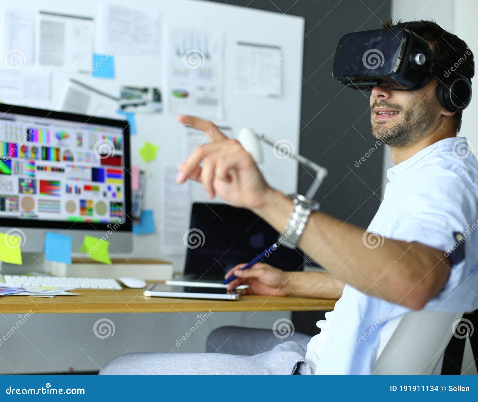 Young Male Software Programmer Testing a New App with 3d Virtual Reality Glasses in Office