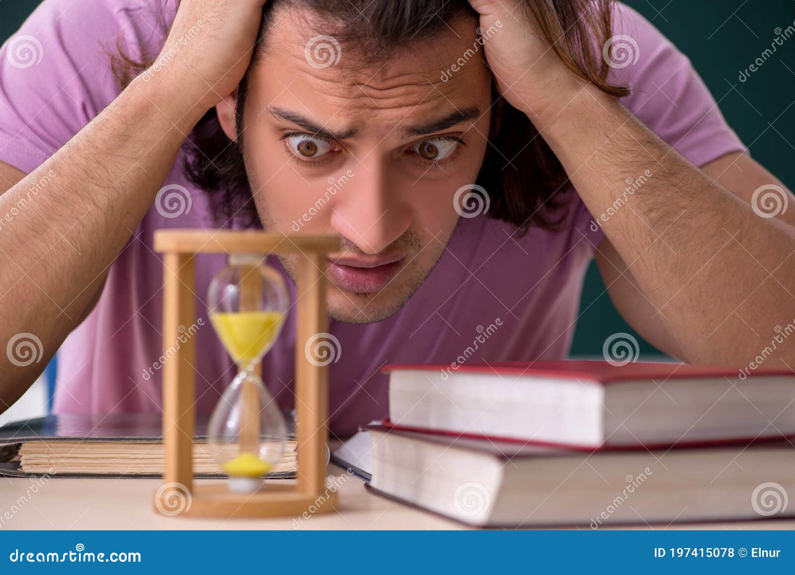 Young Male Student In The Classroom At Time Management Concept Stock