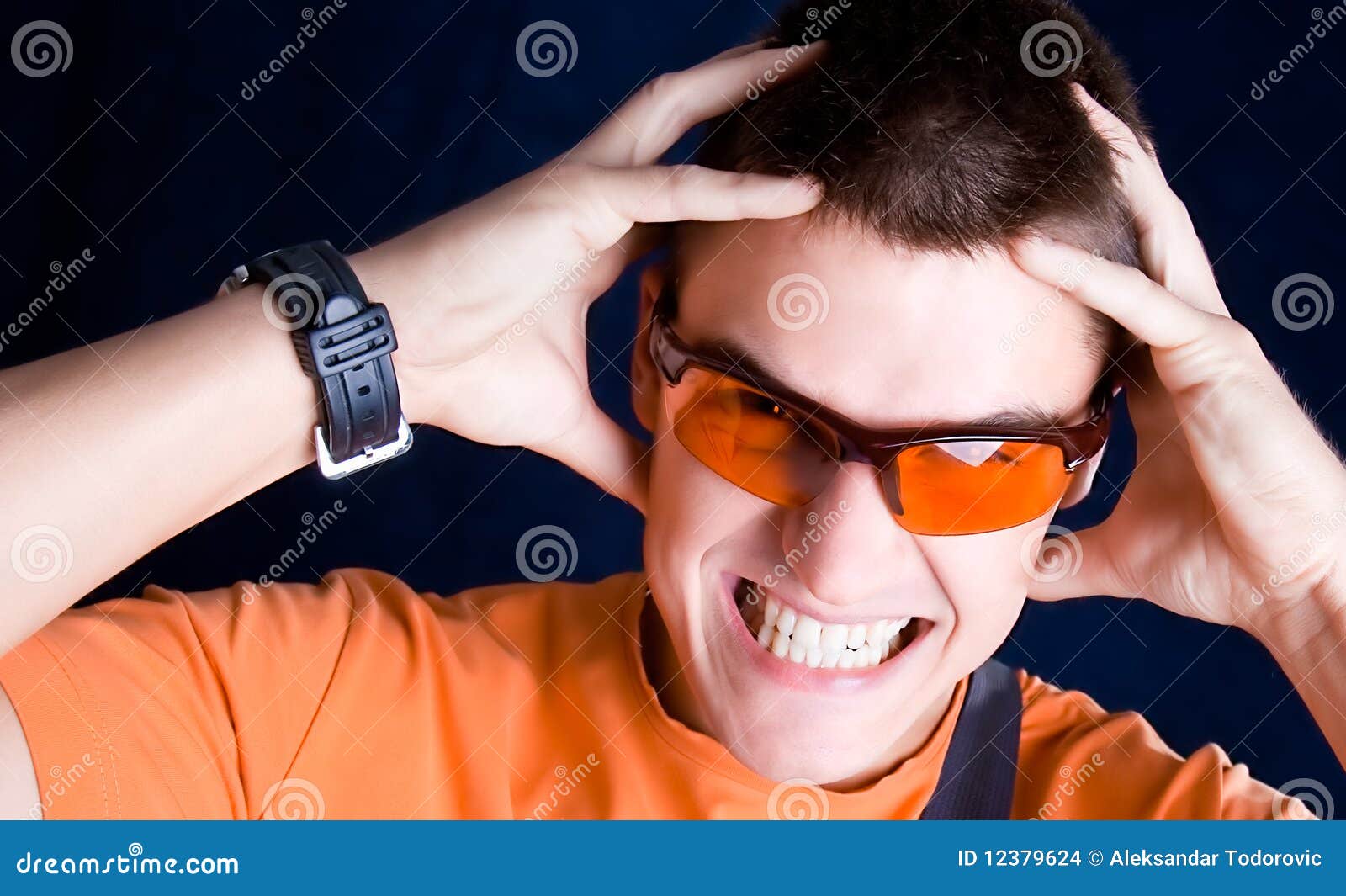 Young Male Whit Orange Sunglasses Hold a Head, Stock Photo Image of