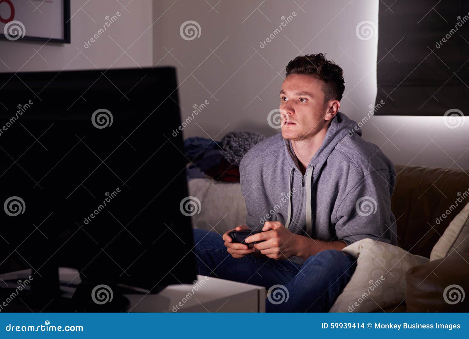 young man addicted to video gaming at home