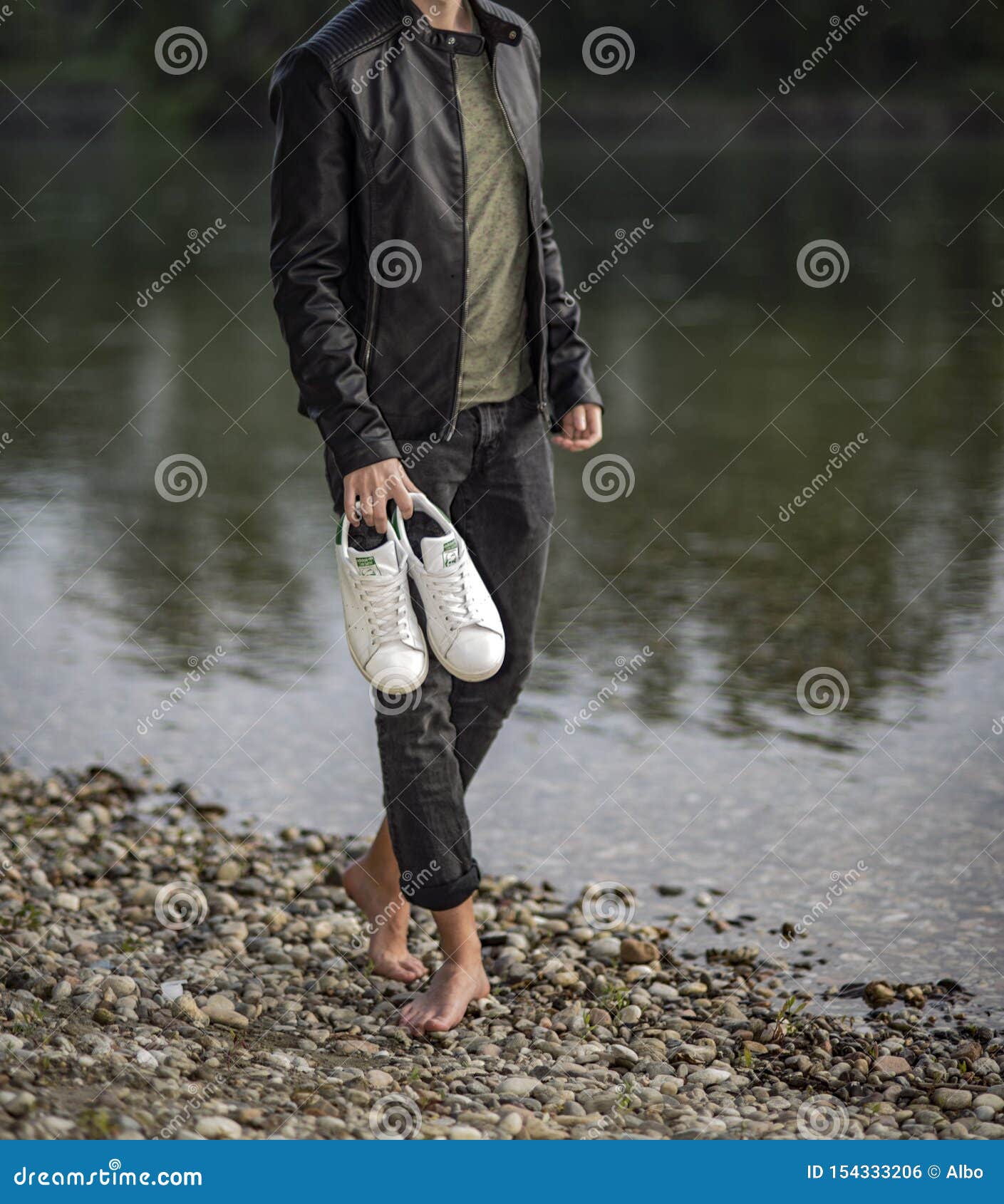 Young Man Barefoot Holding a Pair Adidas Stan Smith Editorial Photo - Image of pavia, isolated: 154333206