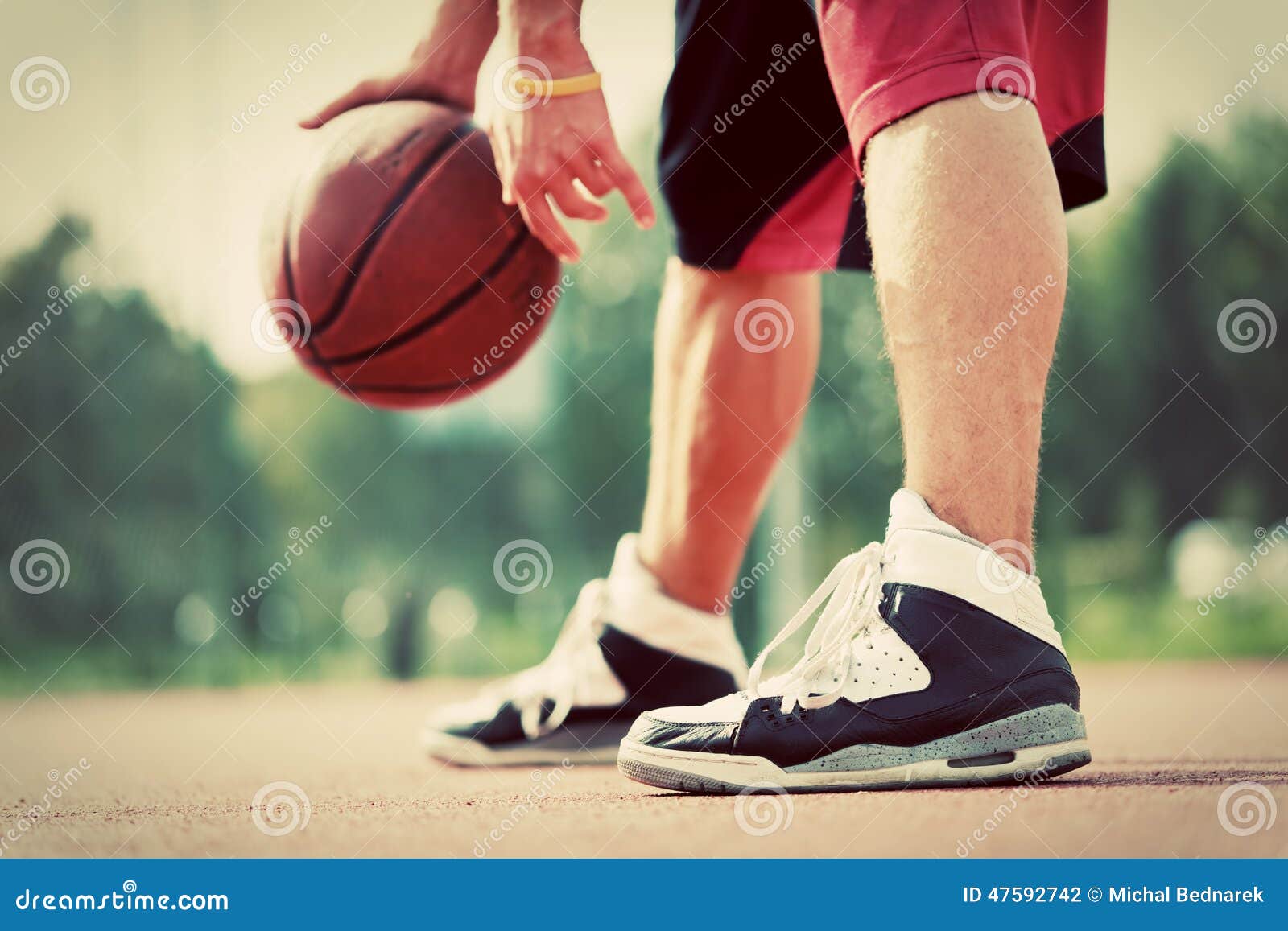 young man on basketball court dribbling with ball