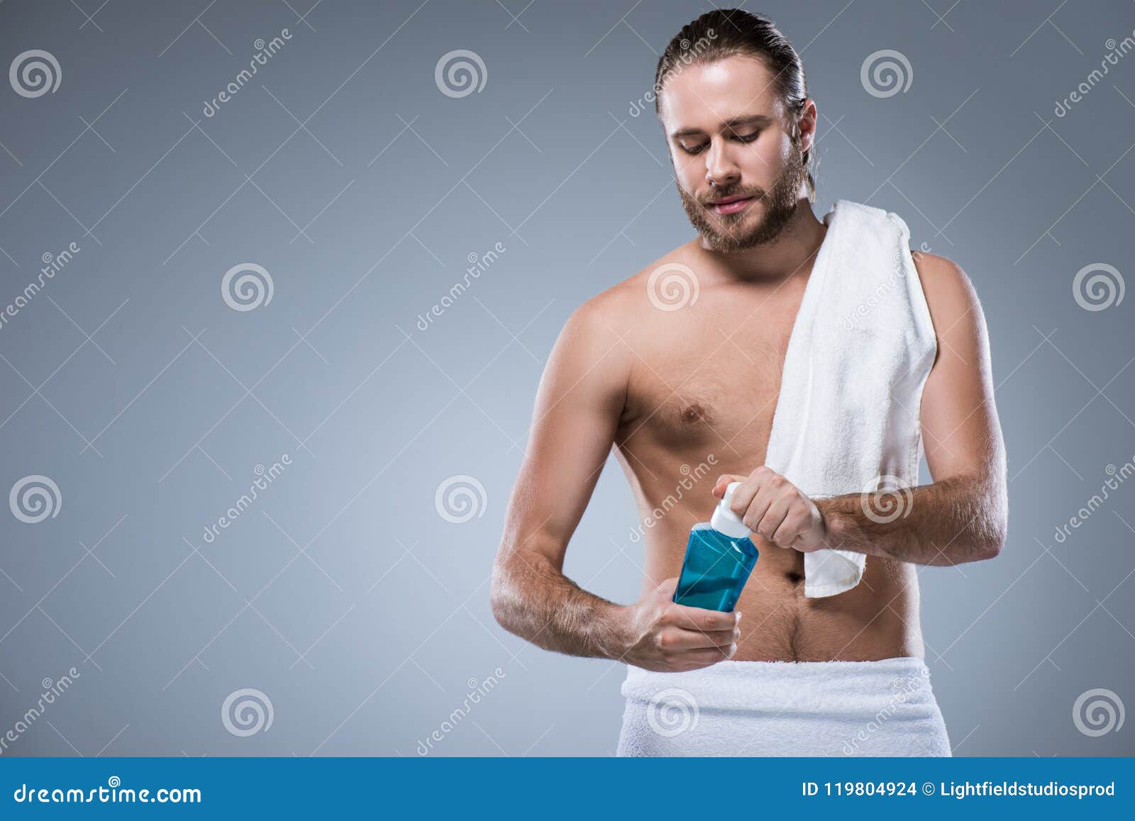 Young Man With Bath Towel On His Shoulder Holding Bottle ...