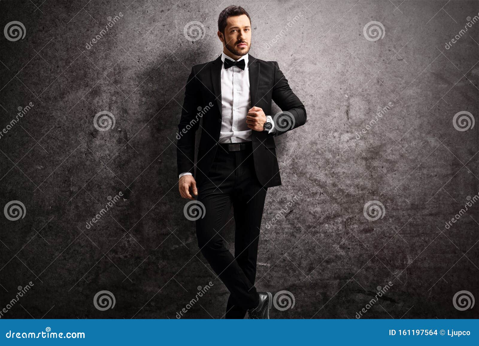 Young Man in a Black Suit and Bow Tie Stock Photo - Image of fashion ...