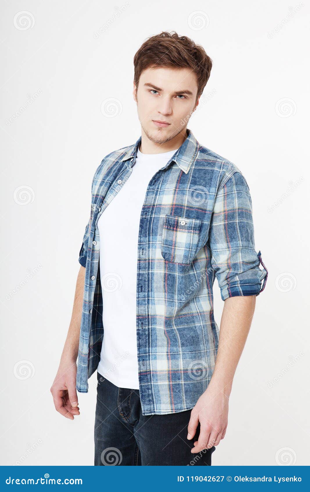 young man in blank summer blank t shirt  on white background. unshaven confident serious male enterpreneur. copy space.