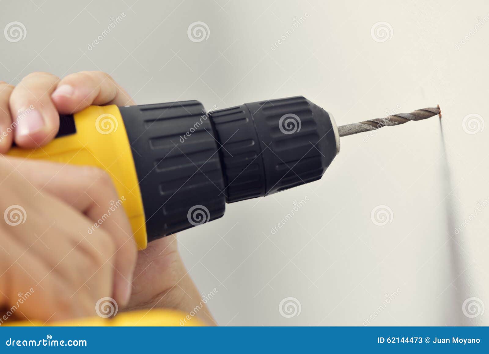 Young Man Boring a Hole in a Wall with a Drill Stock Image Image of