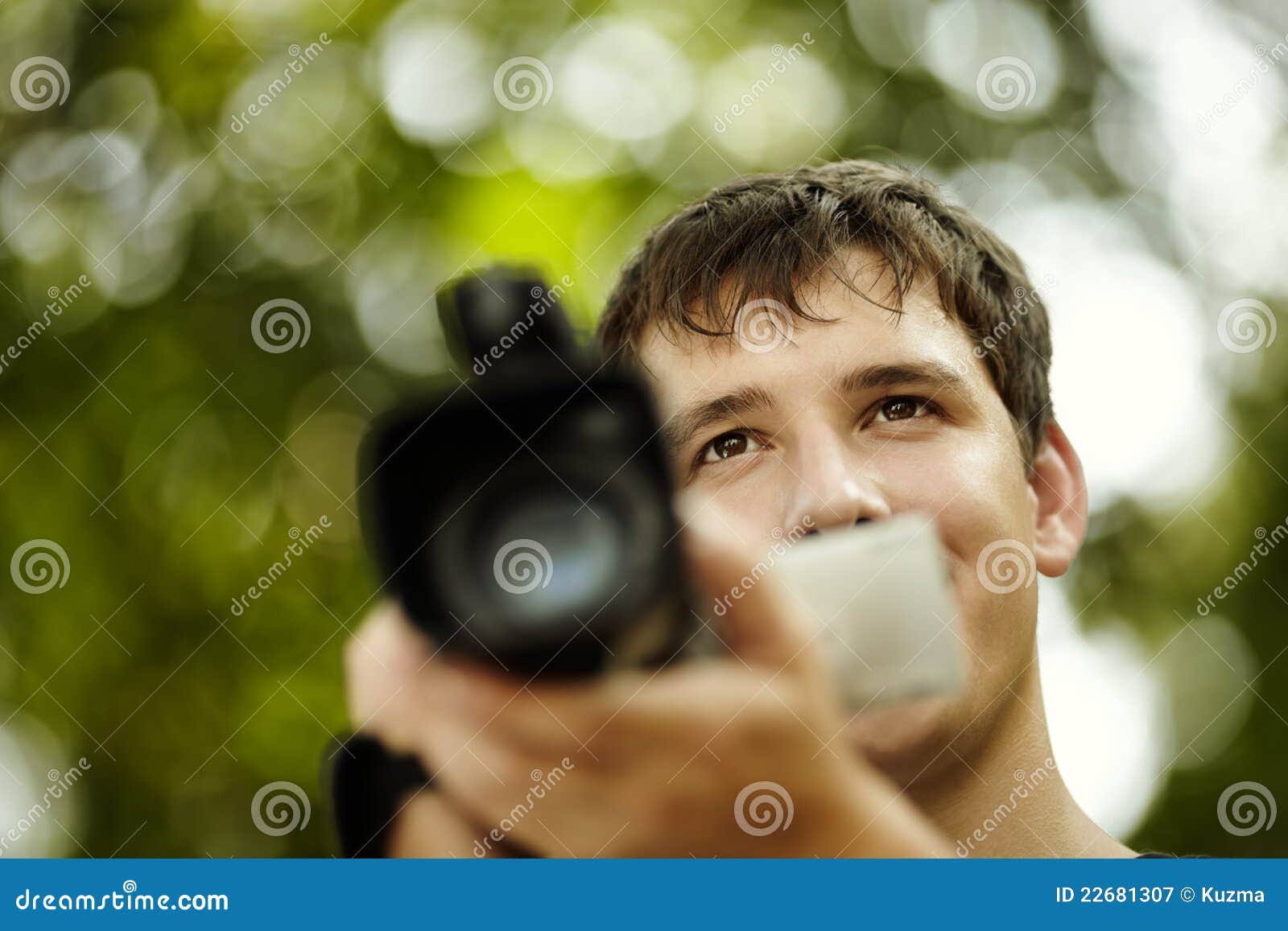 Young man with camcorder stock image. Image of portable 22681307