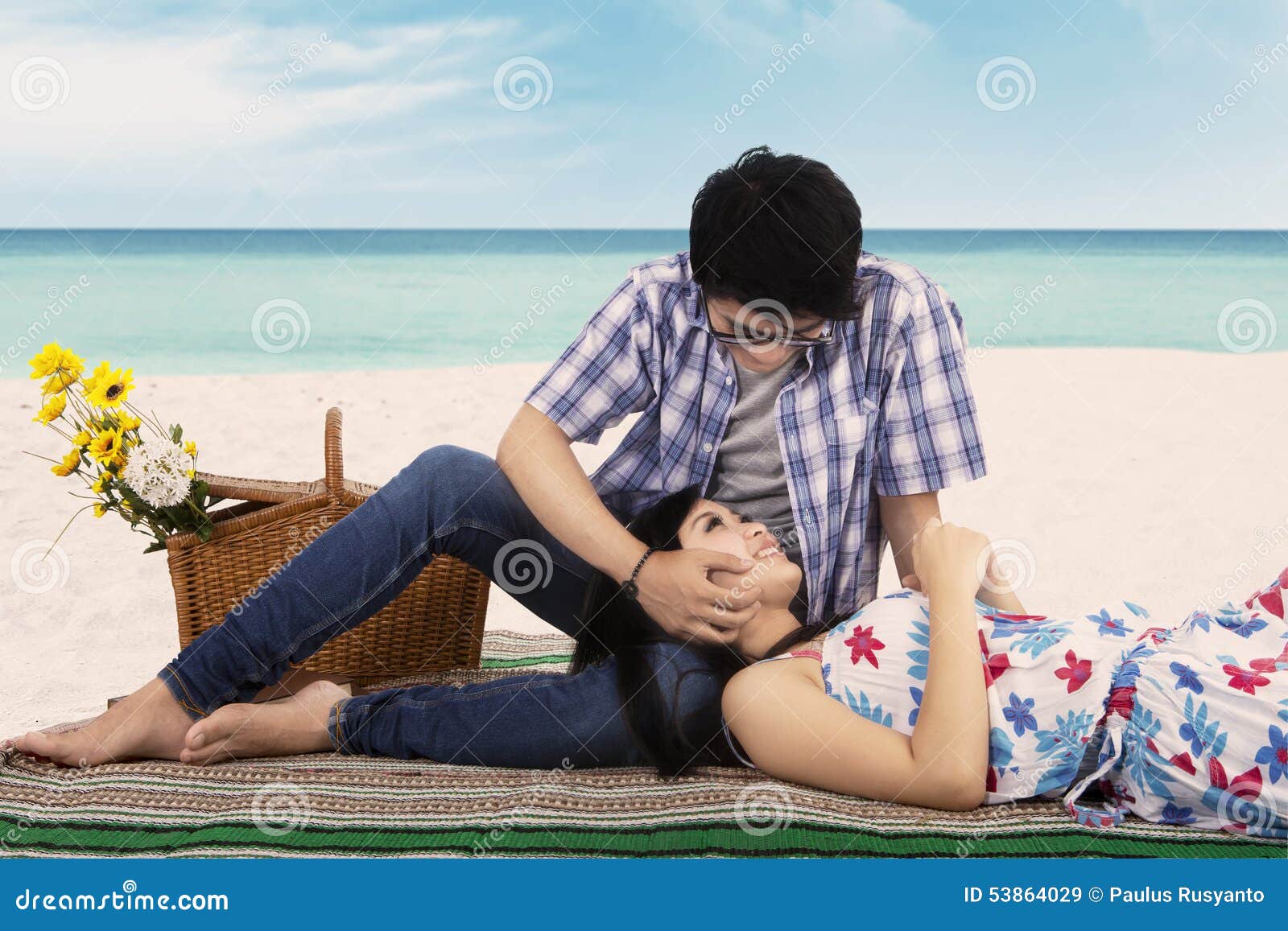 young man caress his girlfriend at beach