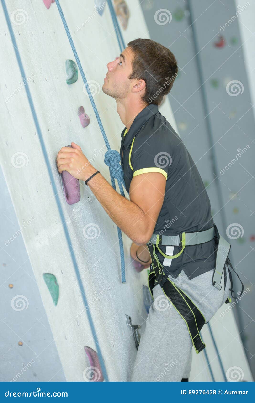 Young man climbing wall stock photo. Image of protect 89276438