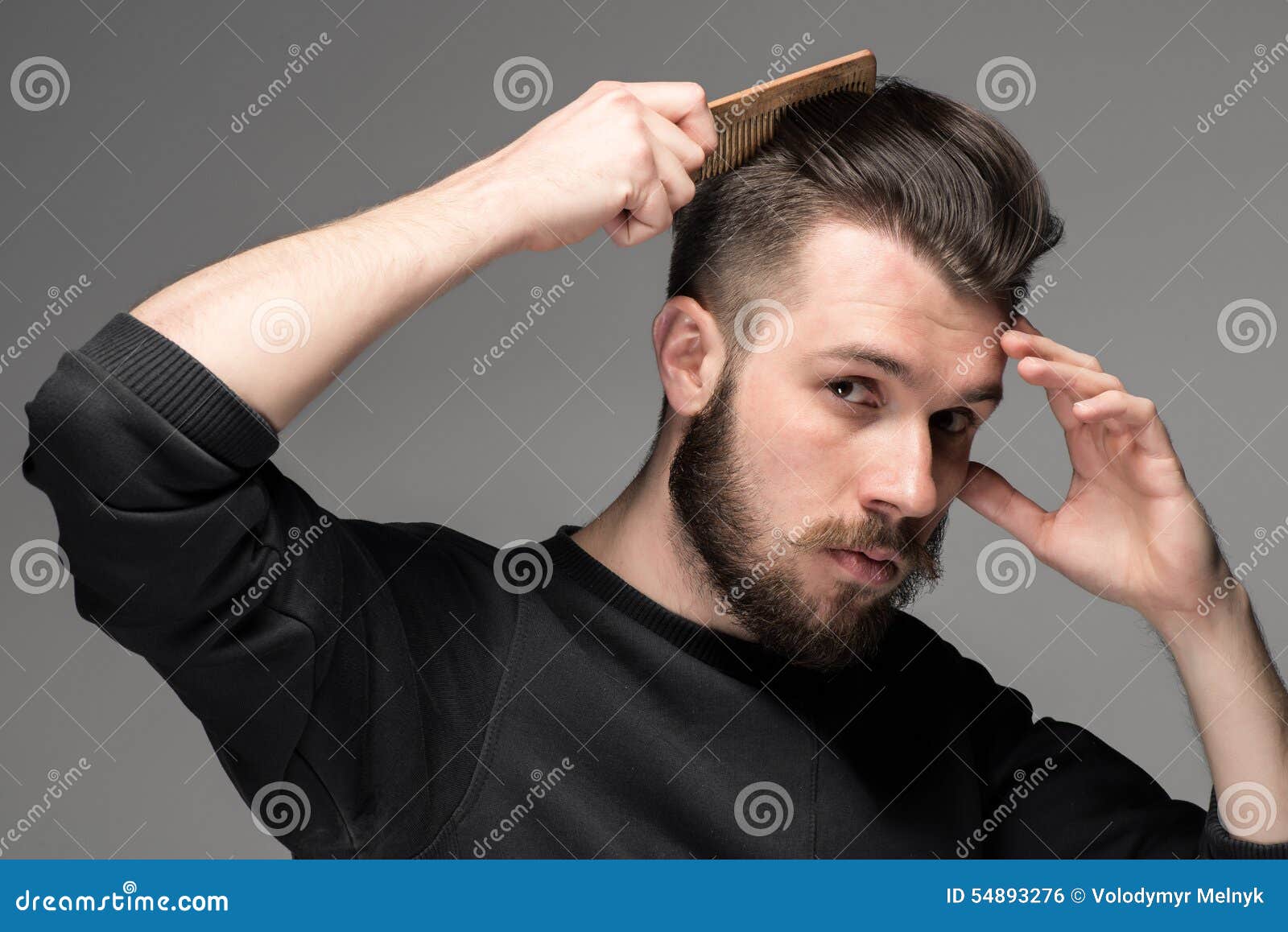Young man comb his hair stock photo. Image of hygiene 54893276