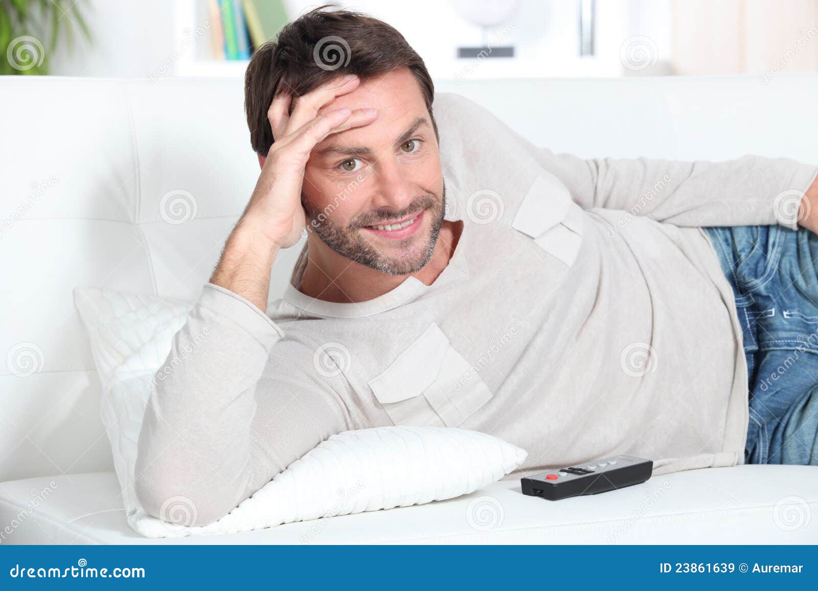 Young man on couch stock image. Image of holidays, vacation 23861639