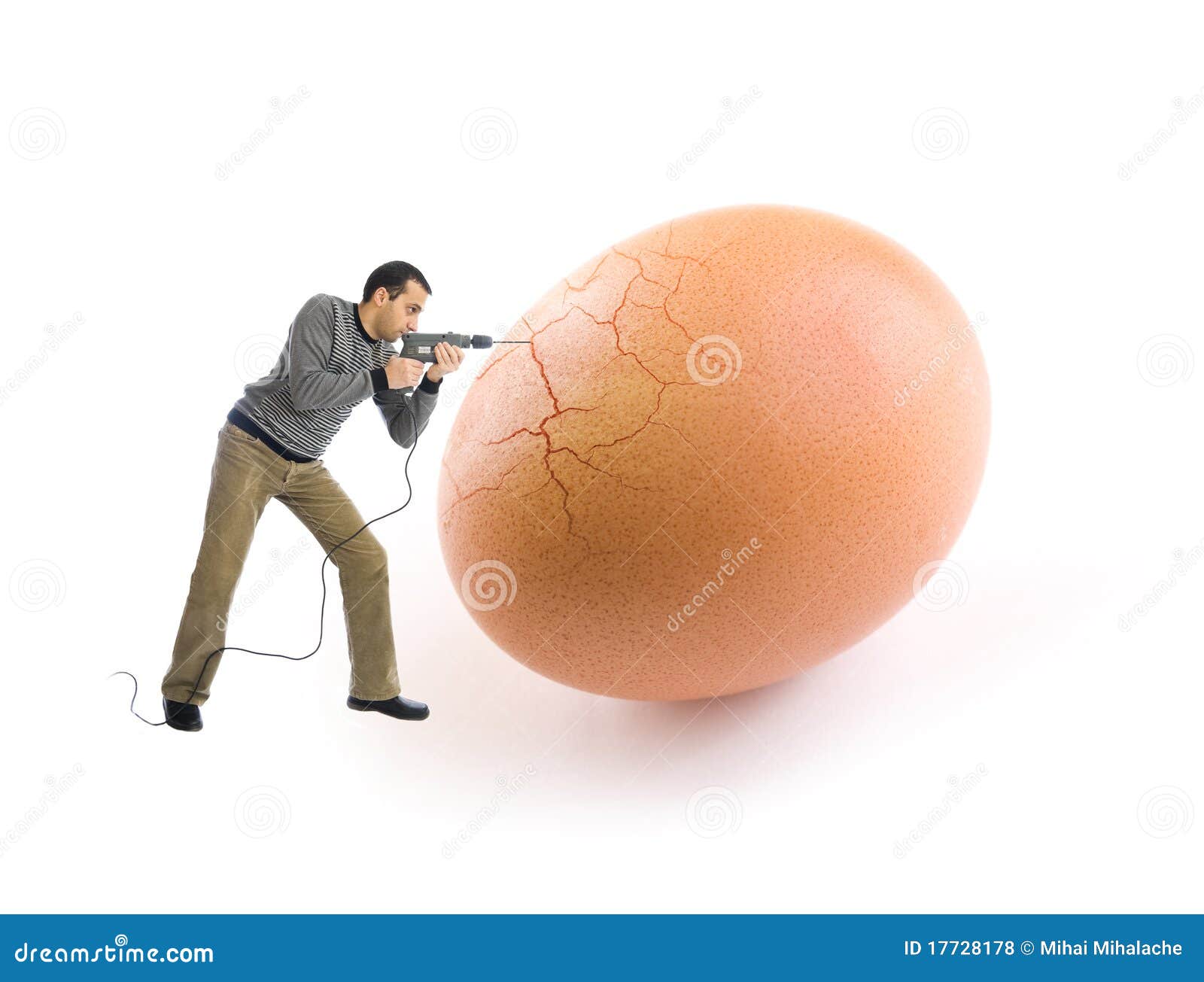 young man cracking an egg using a drill tool